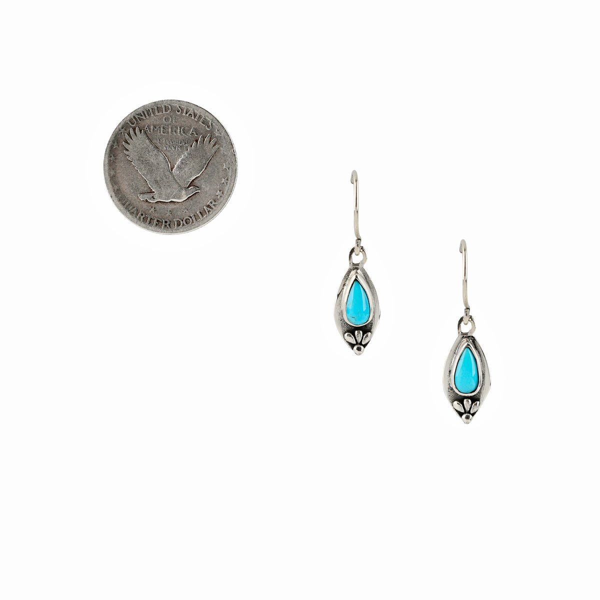 Sterling silver drop earrings with teardrop-shaped blue turquoise stones.