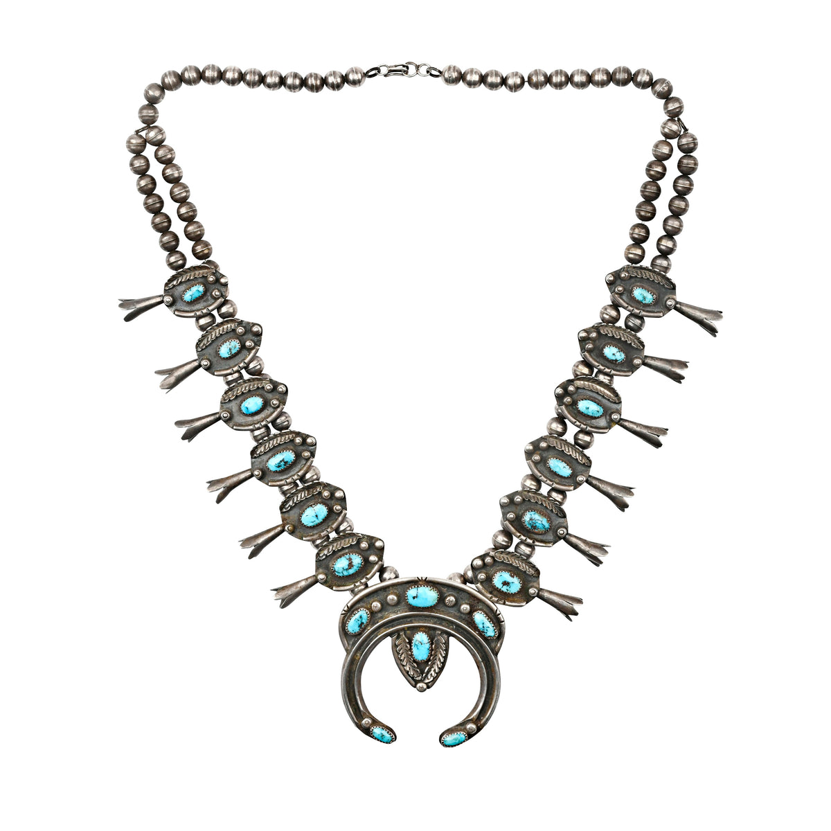 Sterling silver vintage squash blossom necklace with blue turquoise stones .
