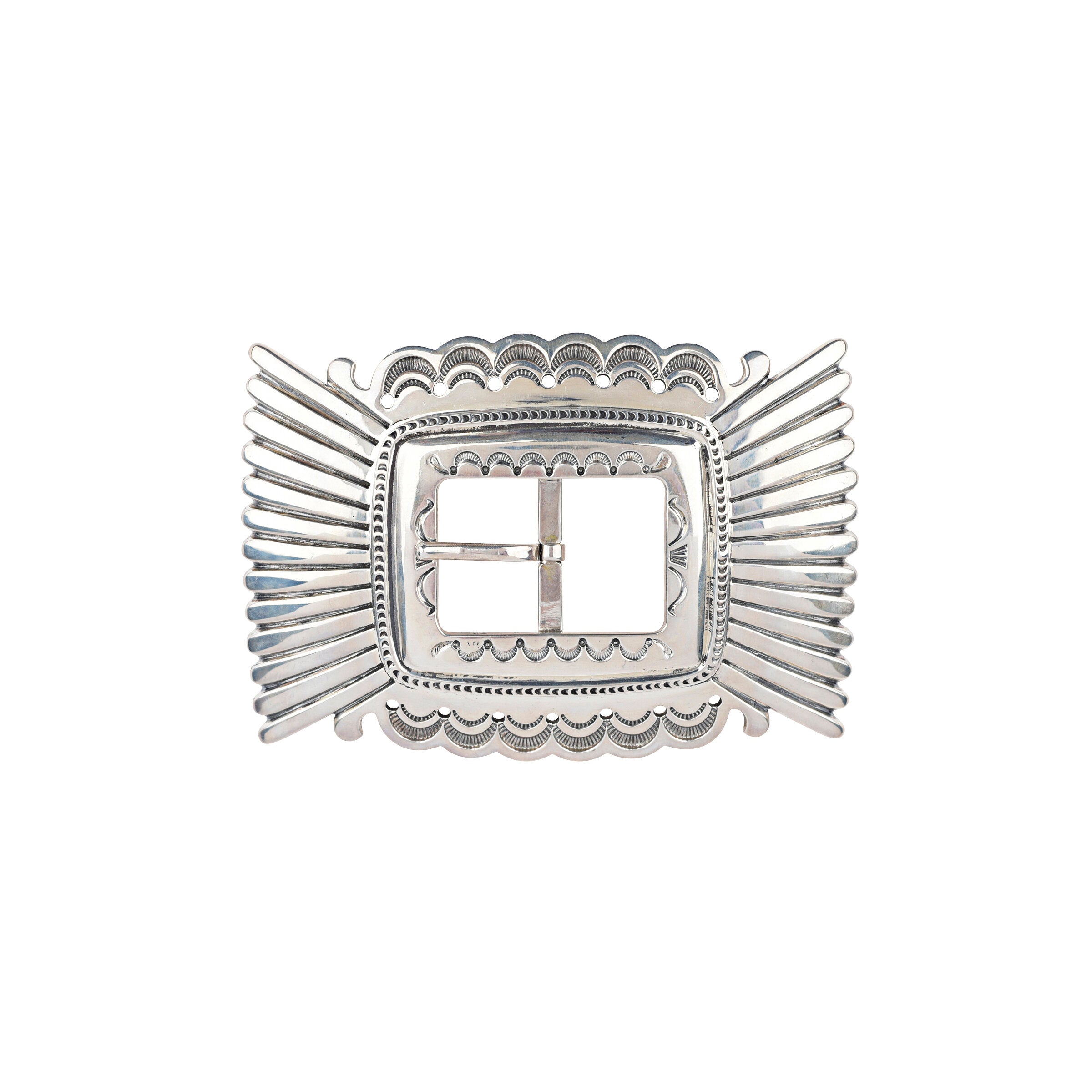 A silver belt buckle with a detailed, intricate pattern, showcasing Navajo craftsmanship.