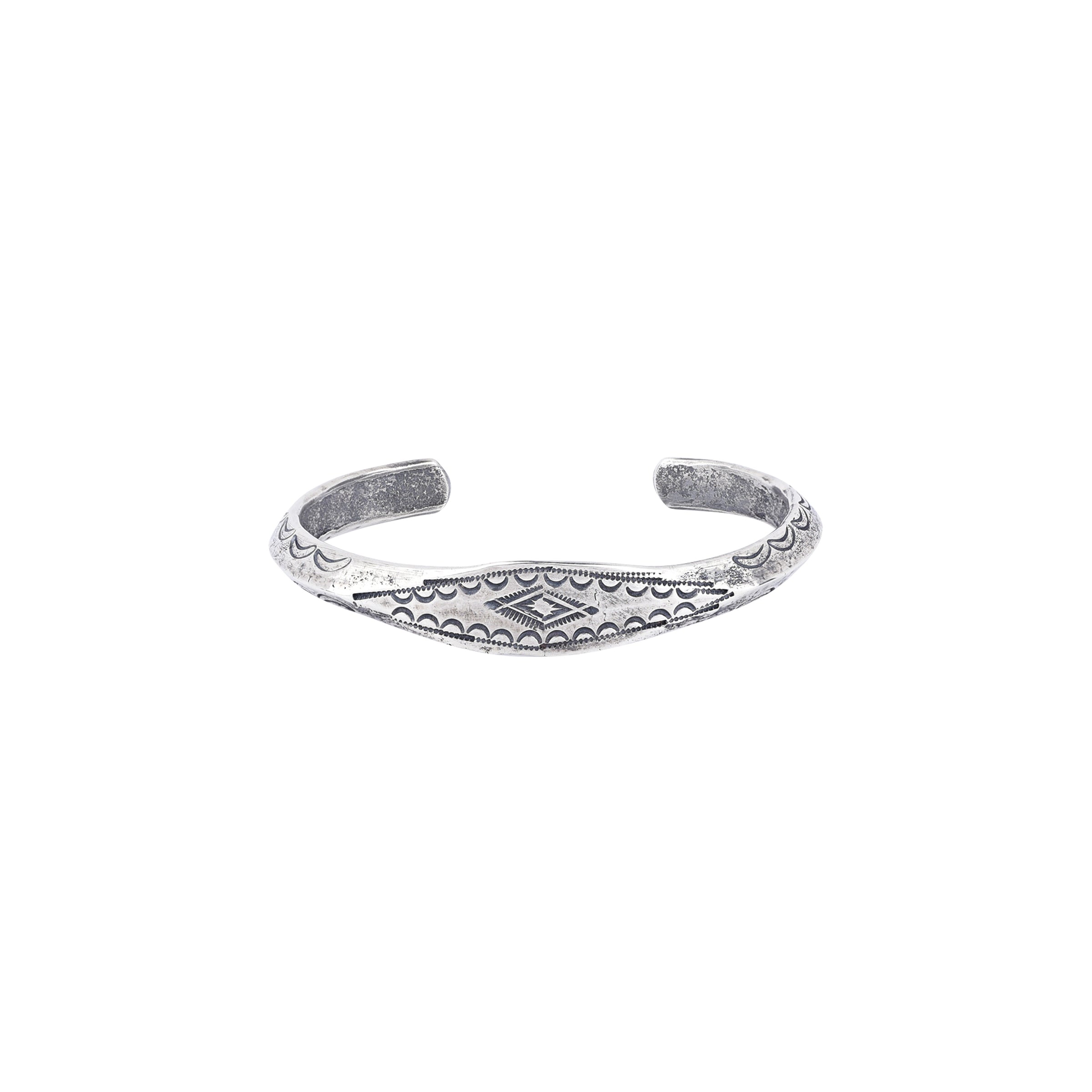 A silver cuff bracelet with intricate stamped patterns, 5 inches in length with a 1/4 inch width.