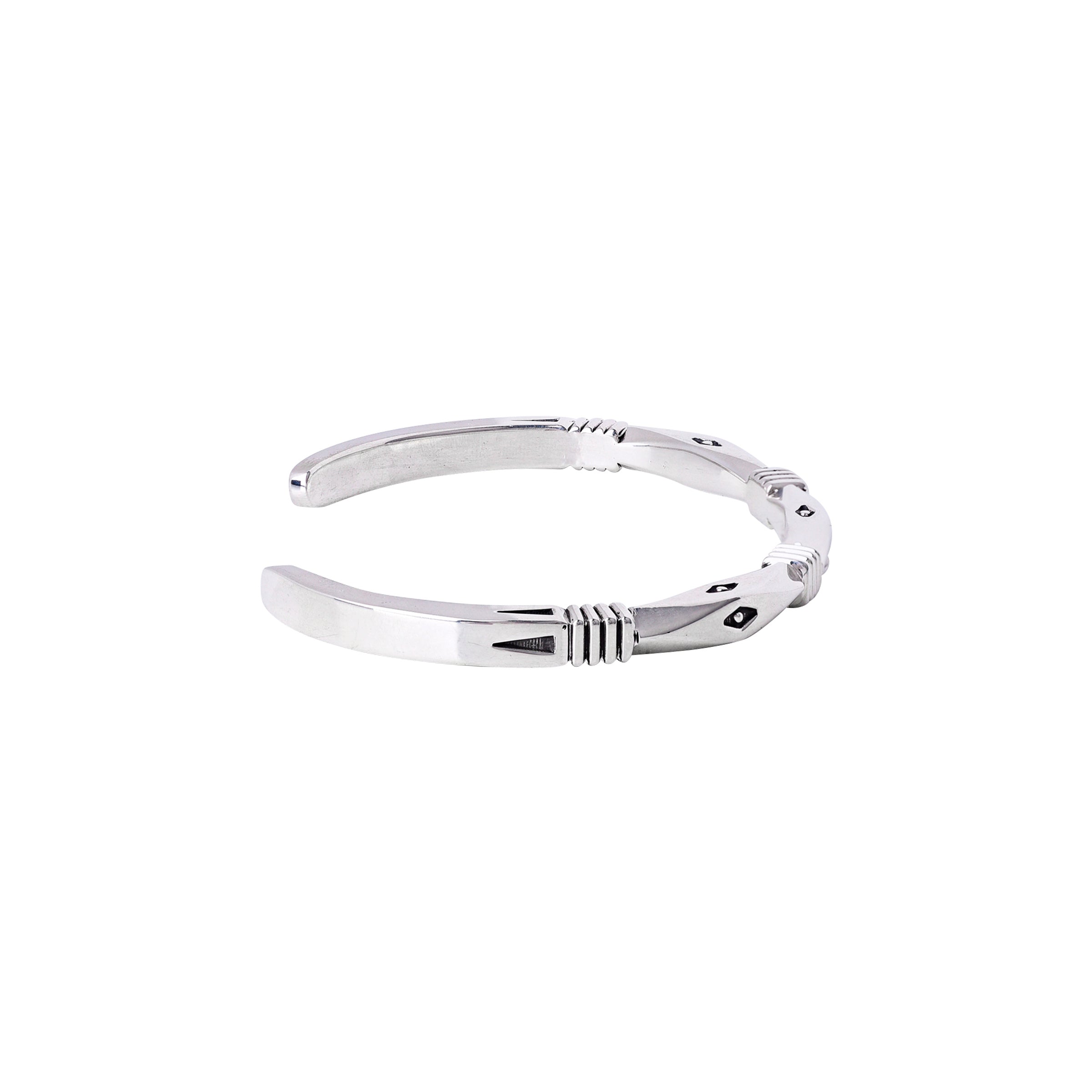 A Sterling silver hand-crafted cuff bracelet with intricate stamping and unique design.