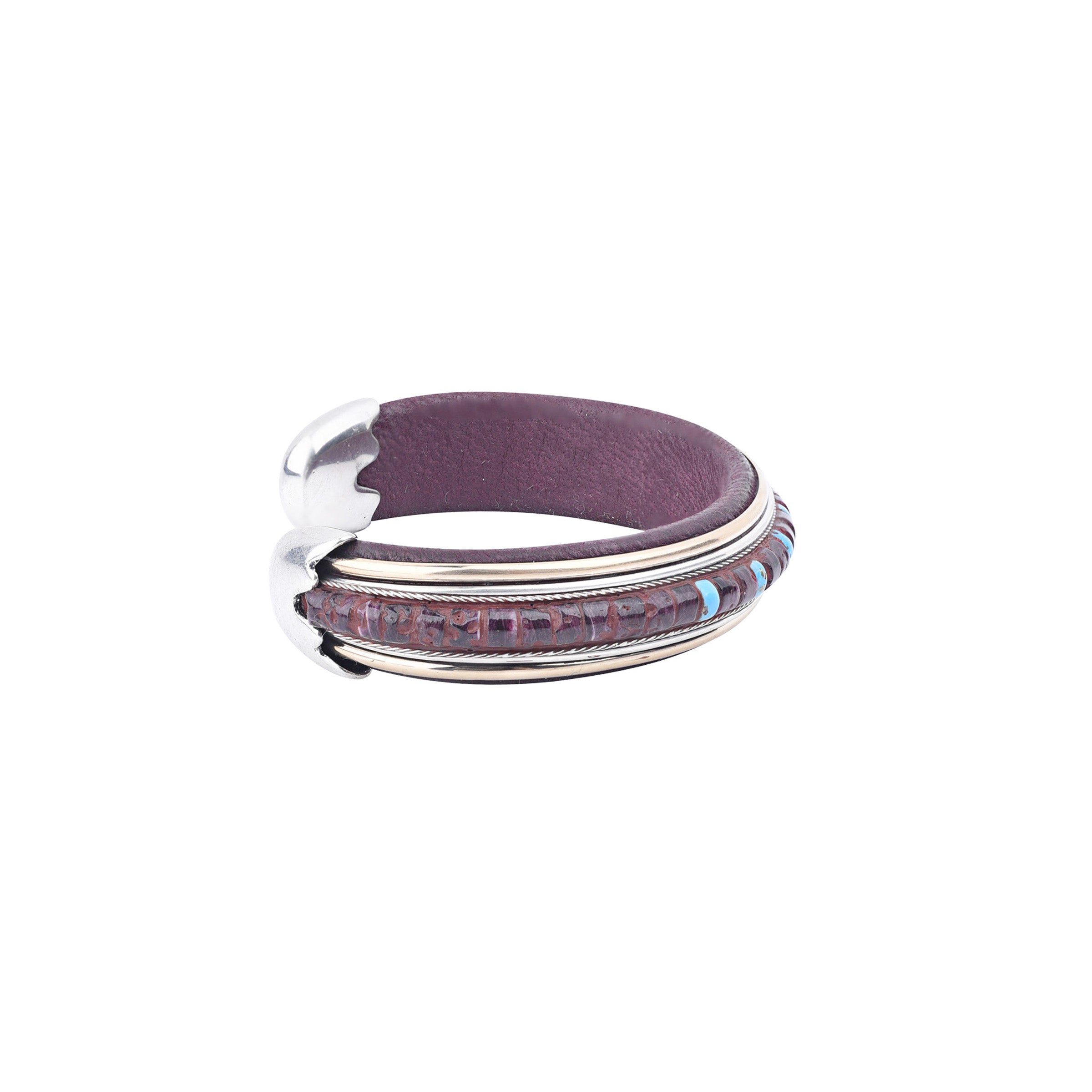 The Mystic Cuff from artist Ramona Heise features soft leather, sterling silver, with blue turquoise stones and purple spiny oyster shell. Made in USA