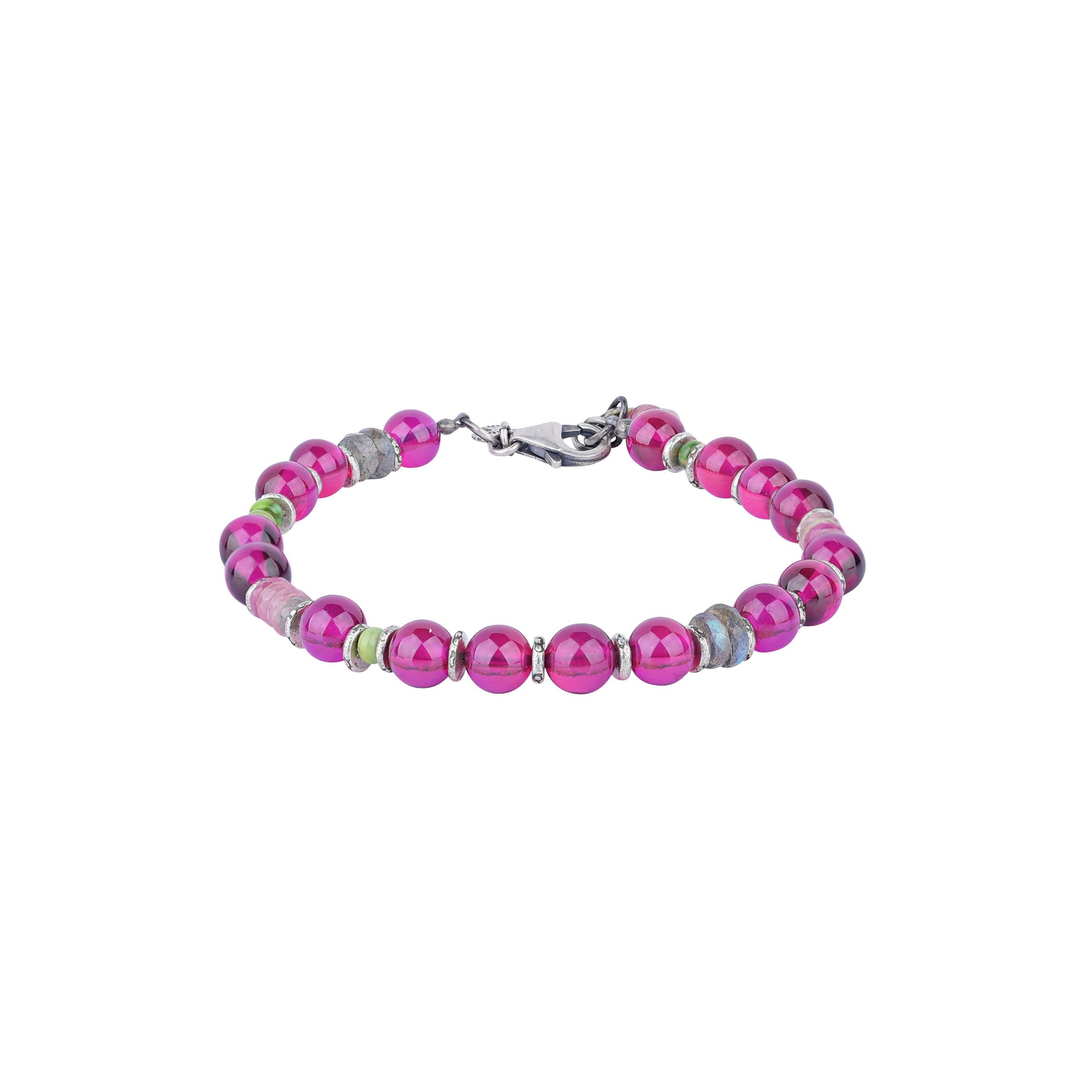 An adjustable bracelet with a mix of ruby, pink sapphire, labradorite, and green turquoise beads, and a sterling silver chain closure.