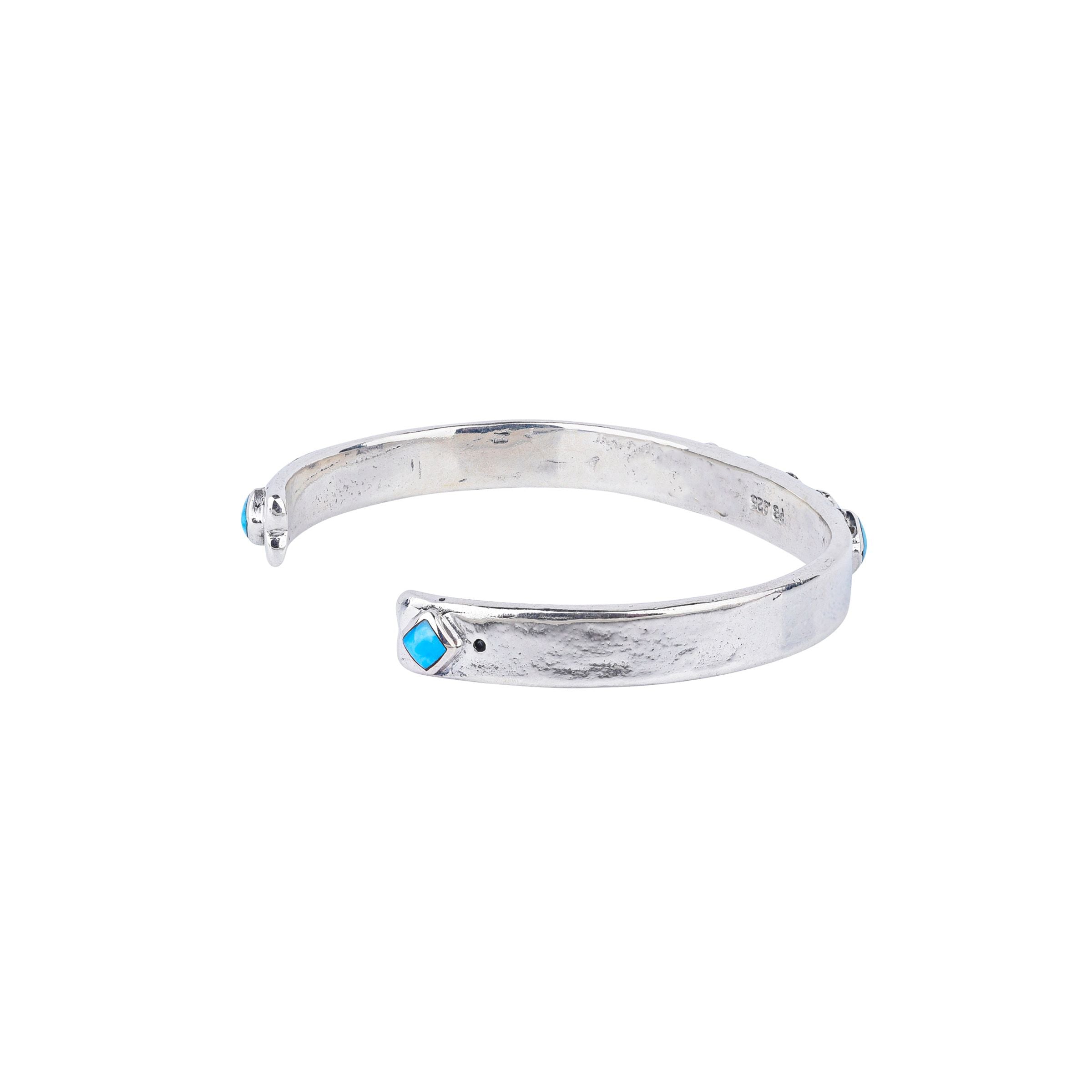 Vintage inspired cuff from our nomad collection that features sterling silver with diamond shaped blue turquoise stones.