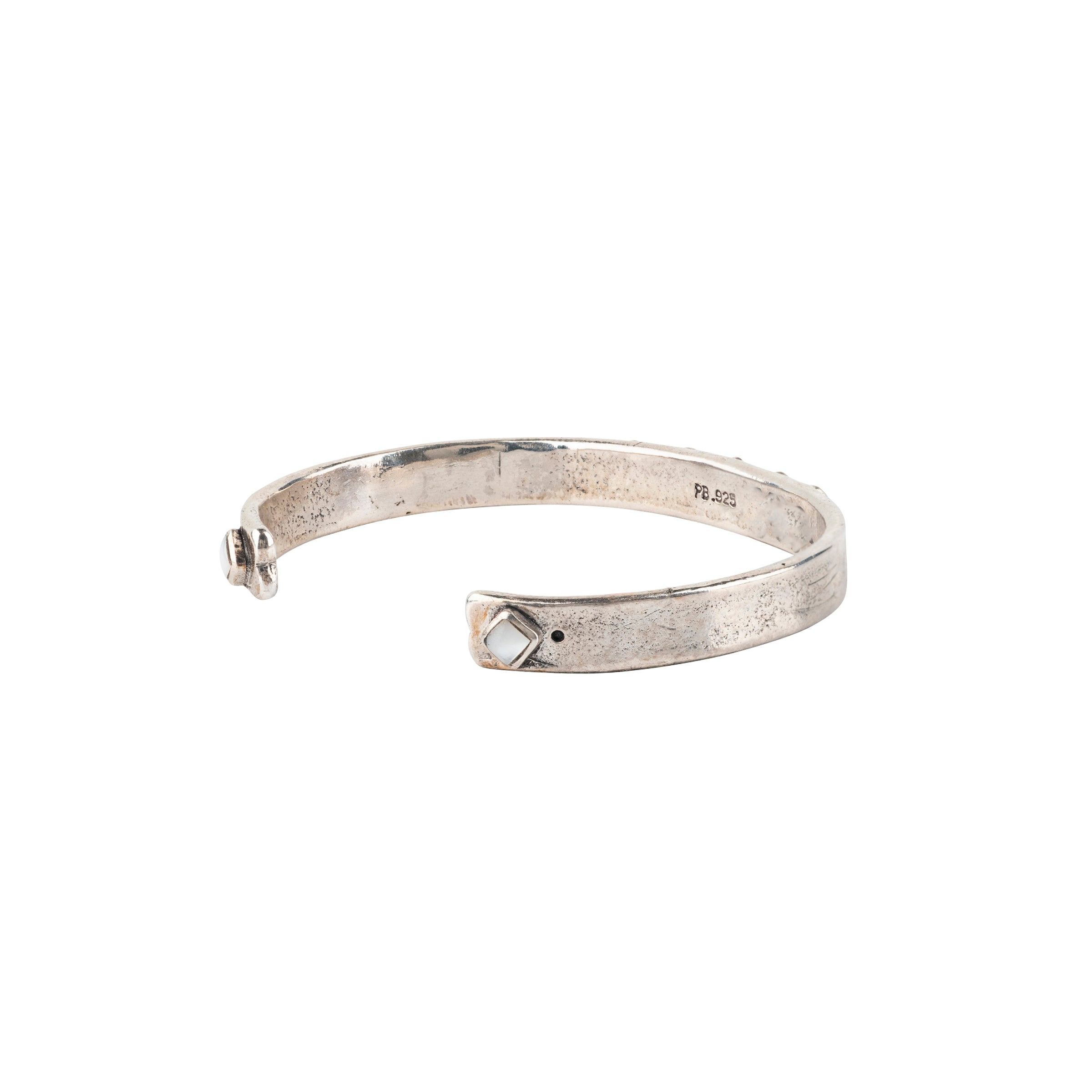 Vintage inspired cuff from our nomad collection that features sterling silver with diamond shaped mother of pearl stones.