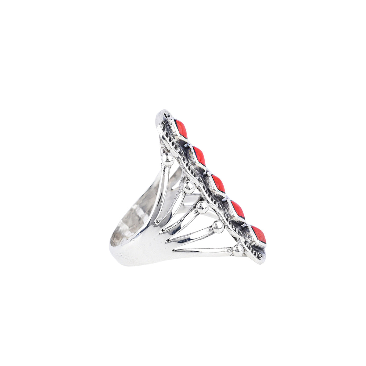 A sterling silver ring with red coral stones in an artistic triangular pattern and a split shank band.