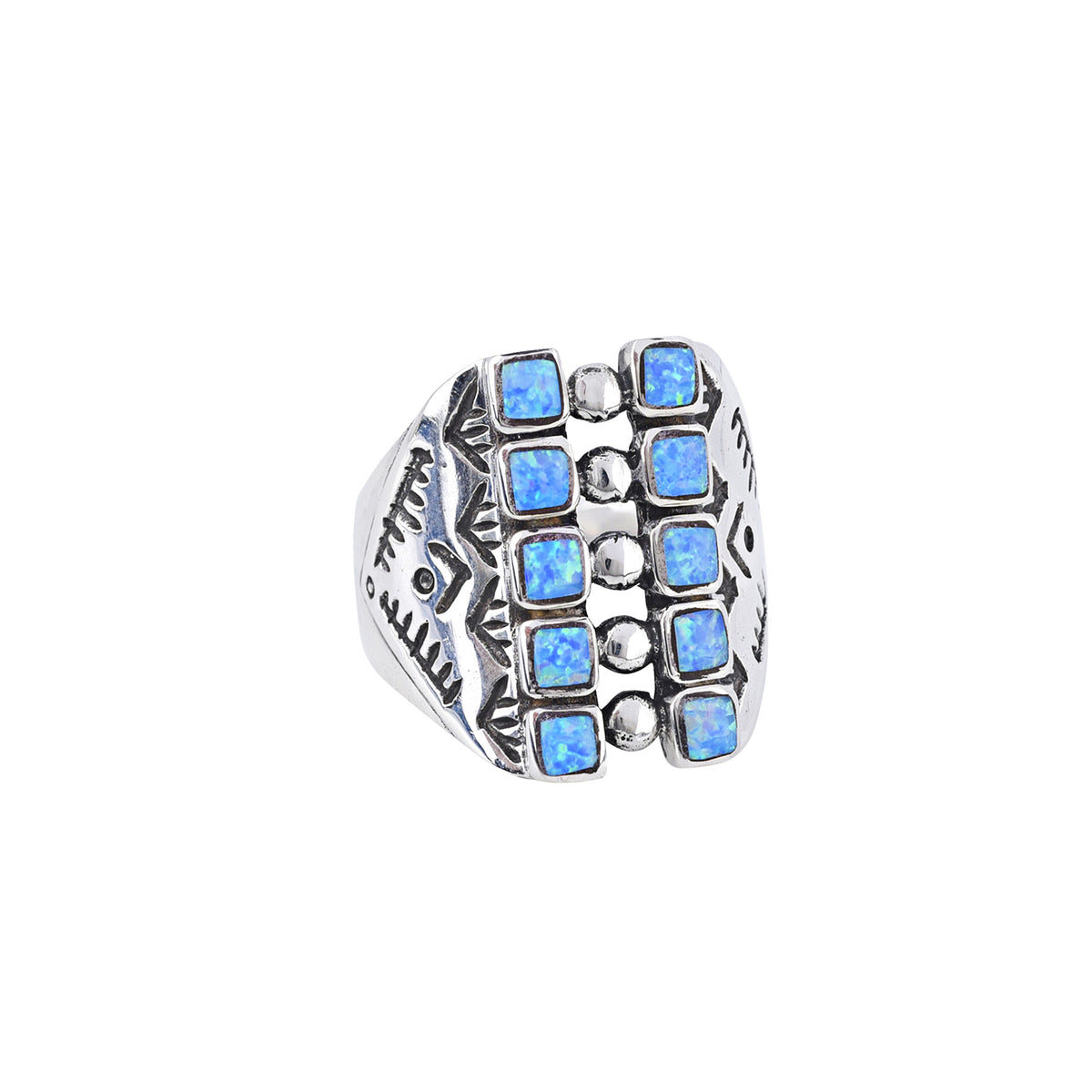A sterling silver shield ring with a geometric pattern, blue opal stones, and detailed southwestern stamping.