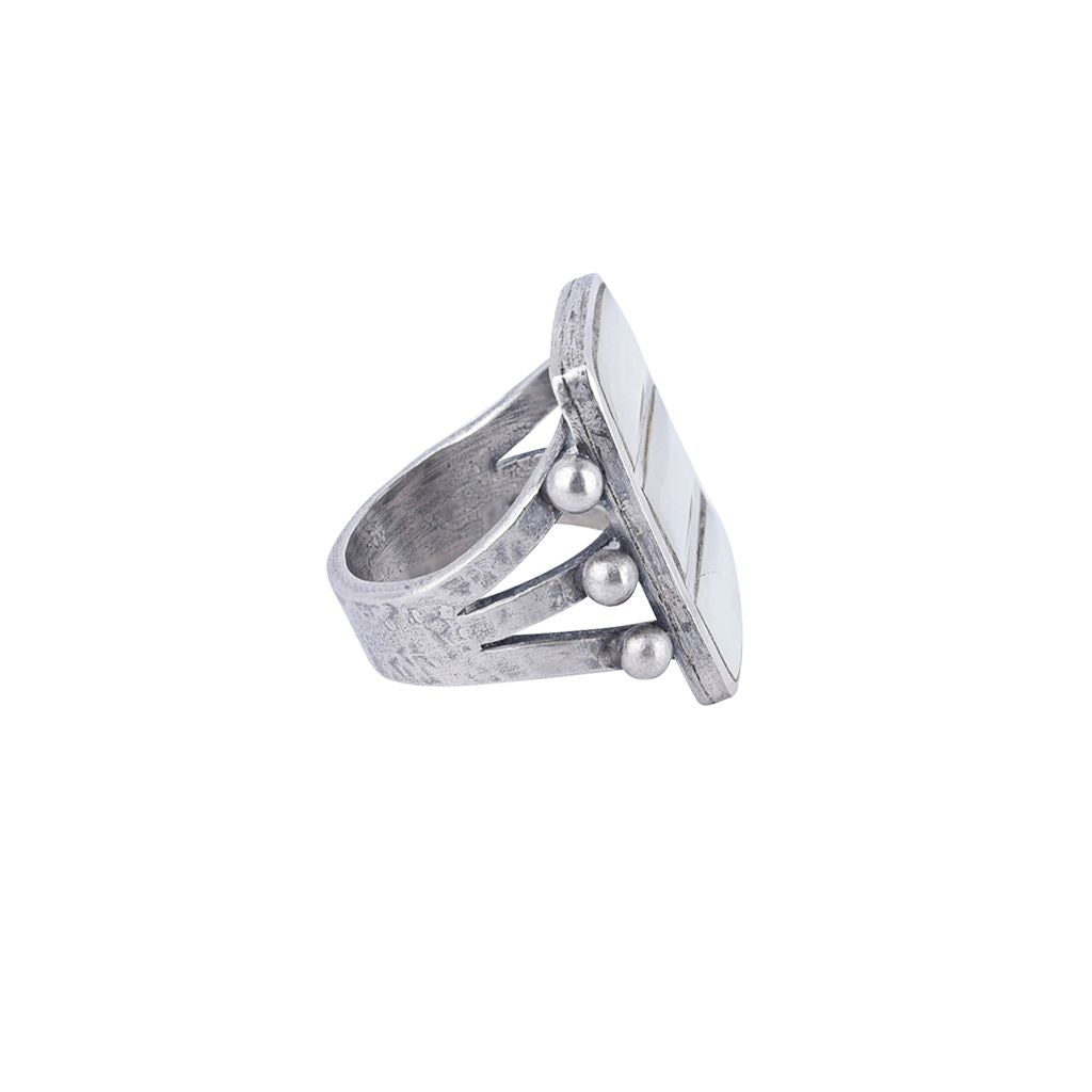 A sterling silver ring featuring three stacked rectangular mother of pearl stones, accented with small silver beads on the sides, with a split shank band.