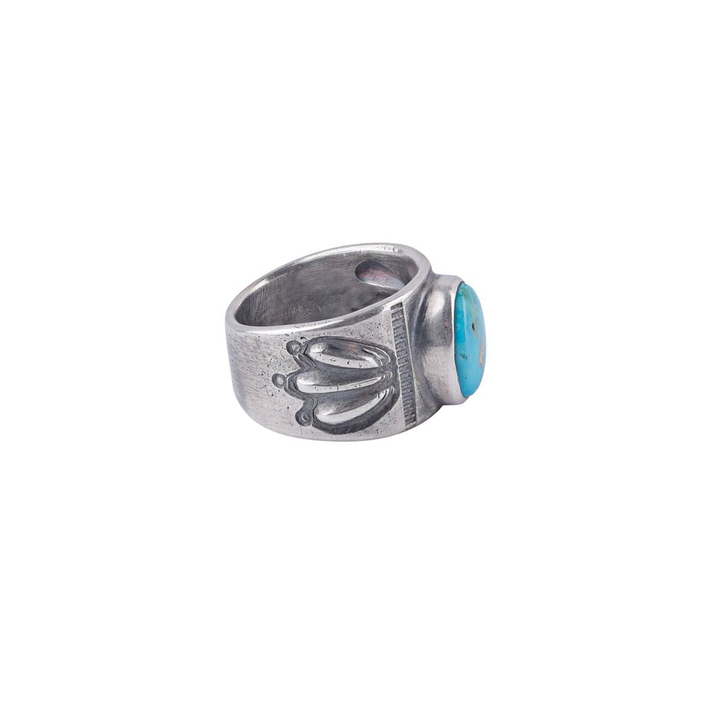 A blue and green turquoise stone ring with an ingot coin silver band, crafted by artisan Jesse Robbins.