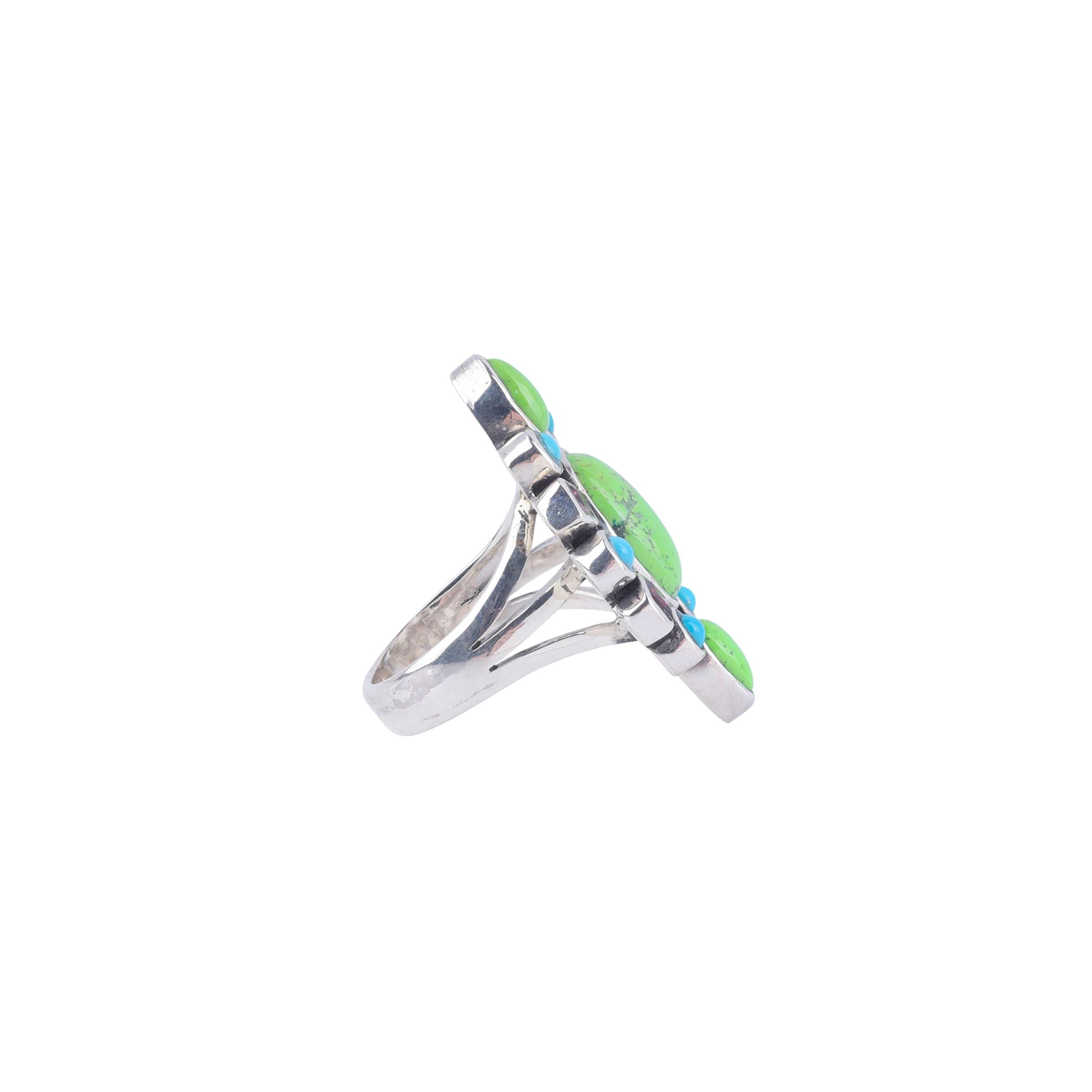 Sterling silver ring with blue turquoise, purple tourmaline, and gaspeite stones set in a geometric pattern.