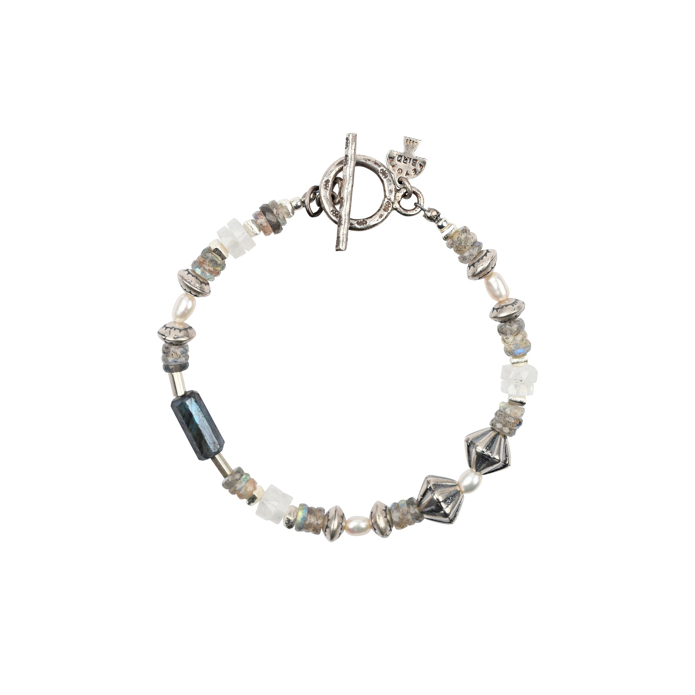 A Peyote Bird Original beaded bracelet strung with Moonstone, Labradorite, Southwestern style sterling silver beading, and stamped sterling silver beads finished with a bar and hoop toggle for a stylish fit