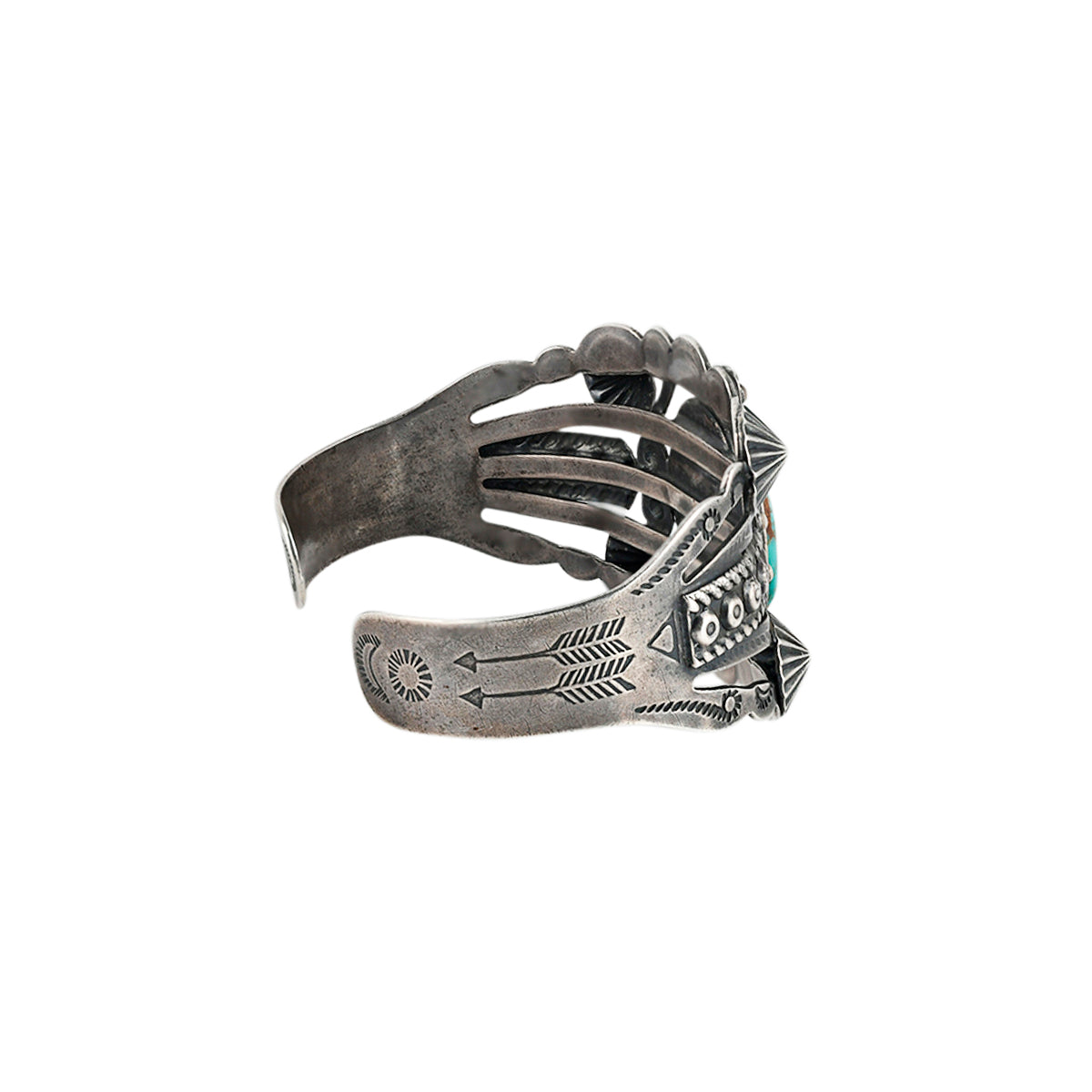 Vintage Navajo sterling silver cuff with turquoise centerpiece and ornate silverwork.