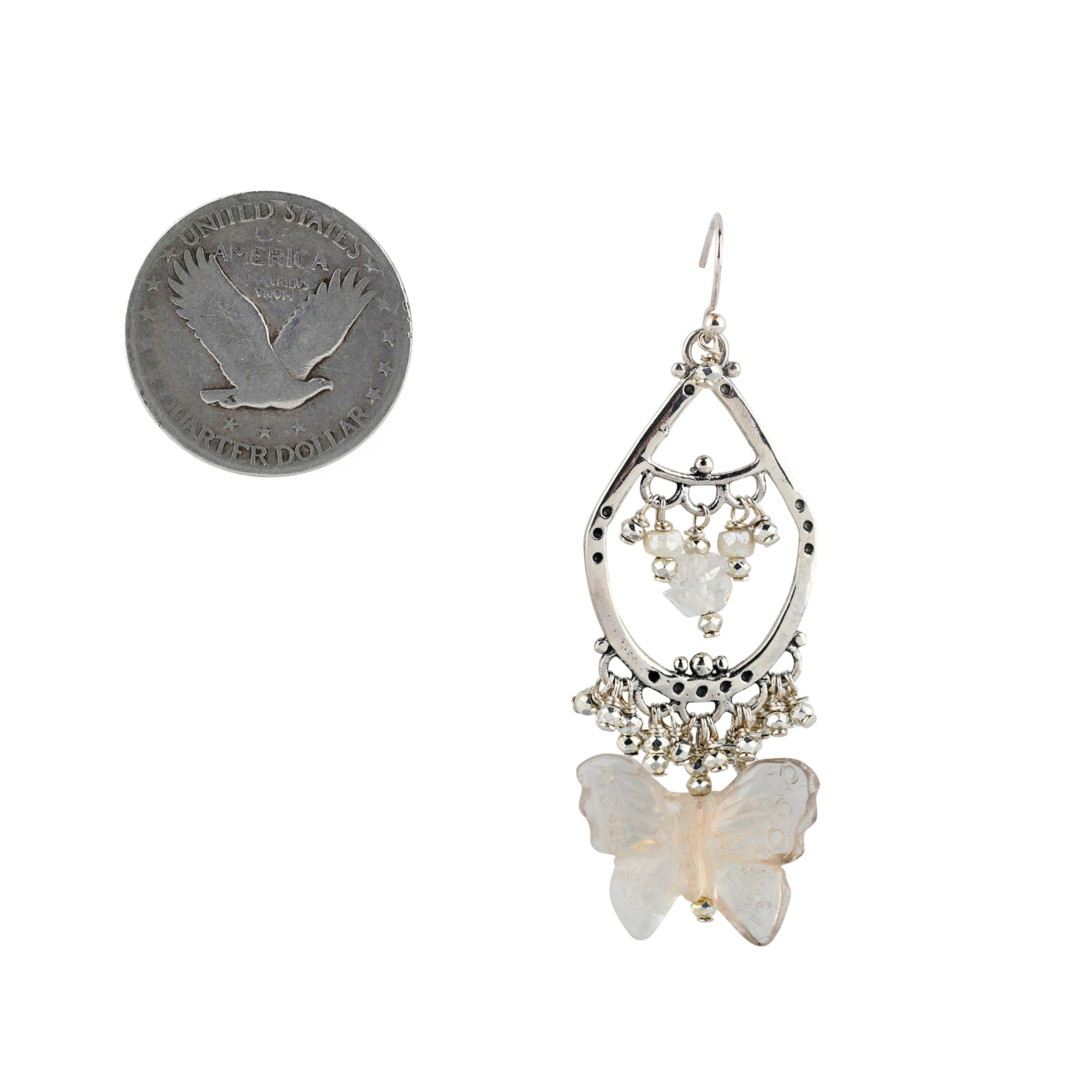 Sterling Silver hoop earring with white charms and butterfly charm focal point next to coin for scale.