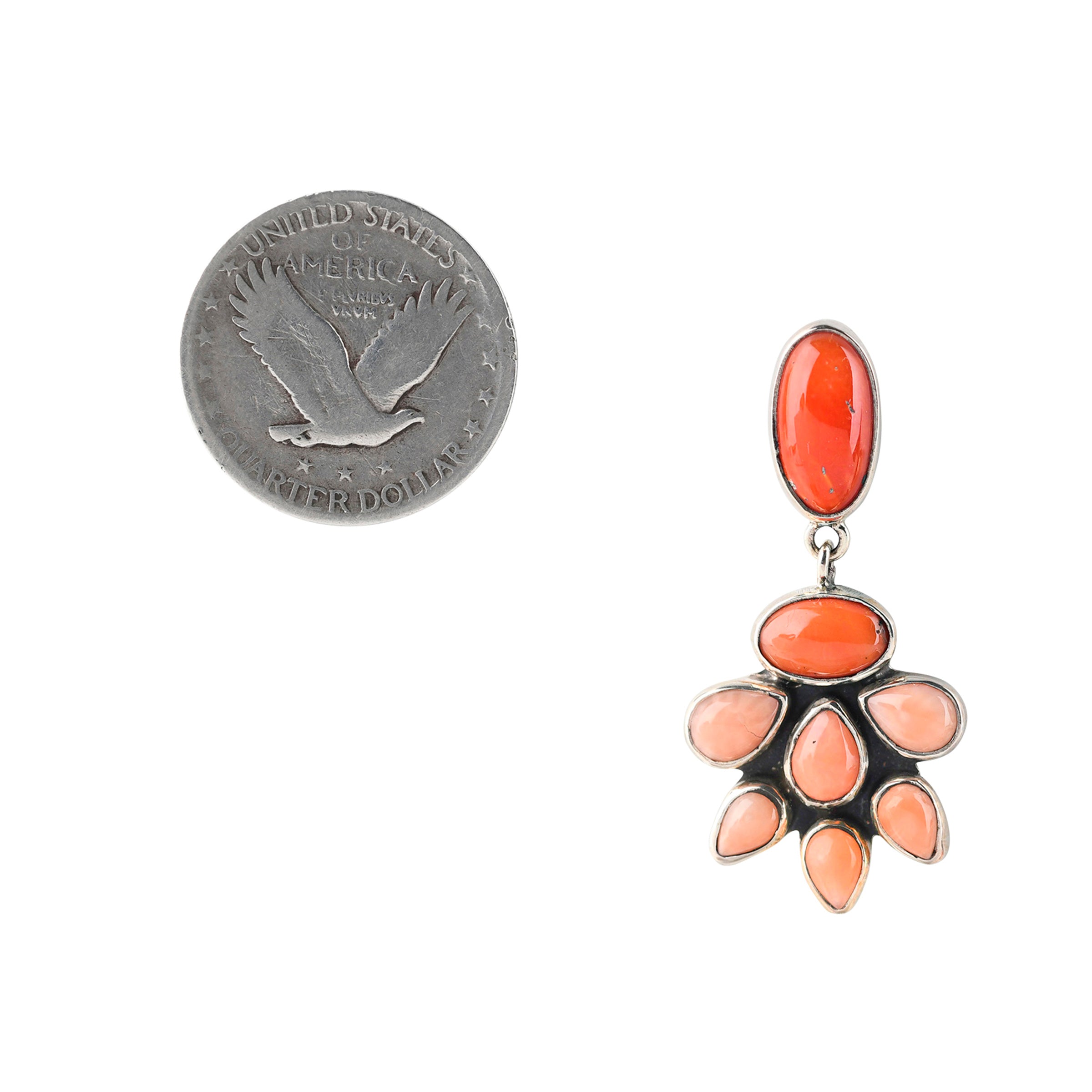 Sterling silver wrapped pink, red, and orange coral earring next to coin for scale.