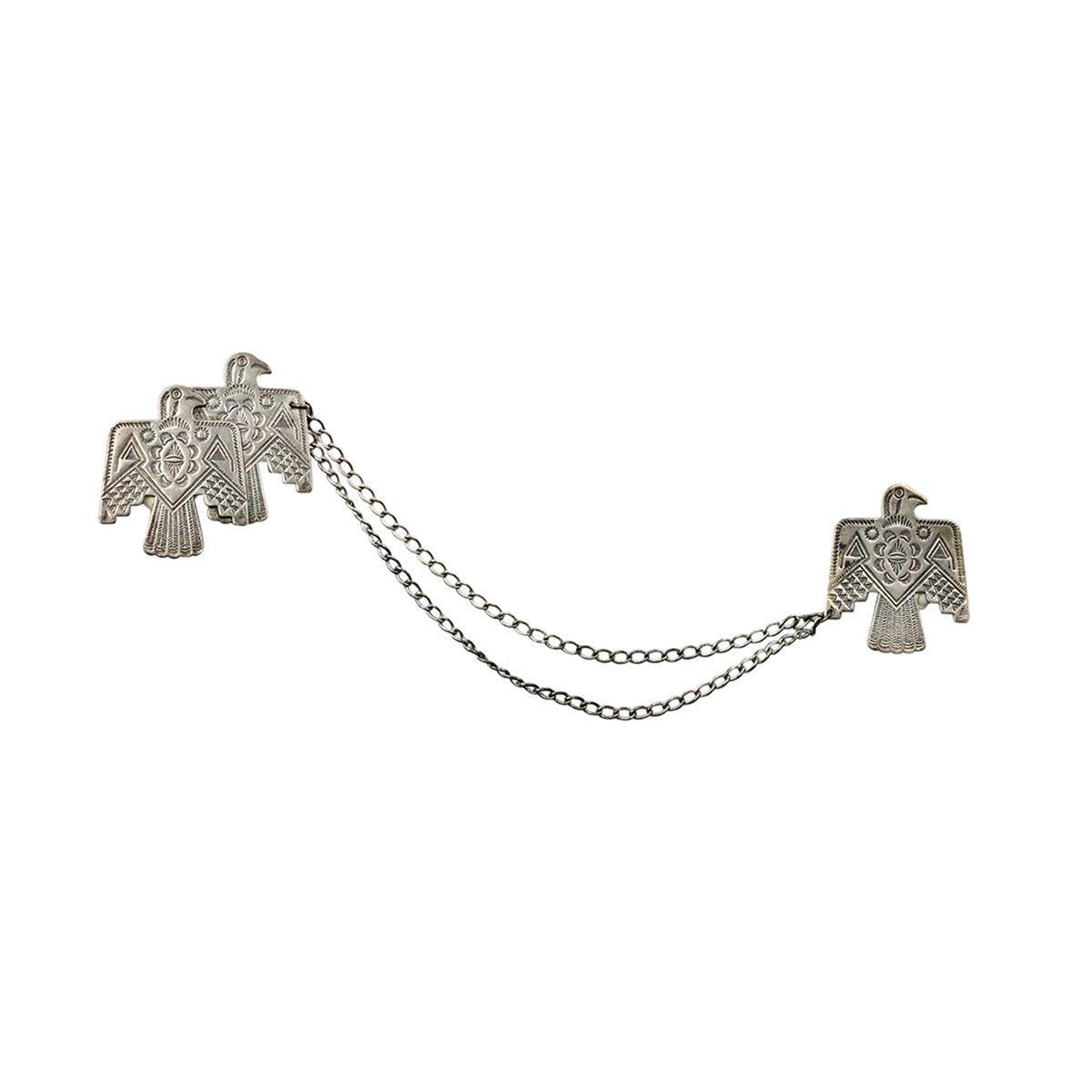 Two sterling silver thunderbird pins stamped with southwestern designs connected by chain
