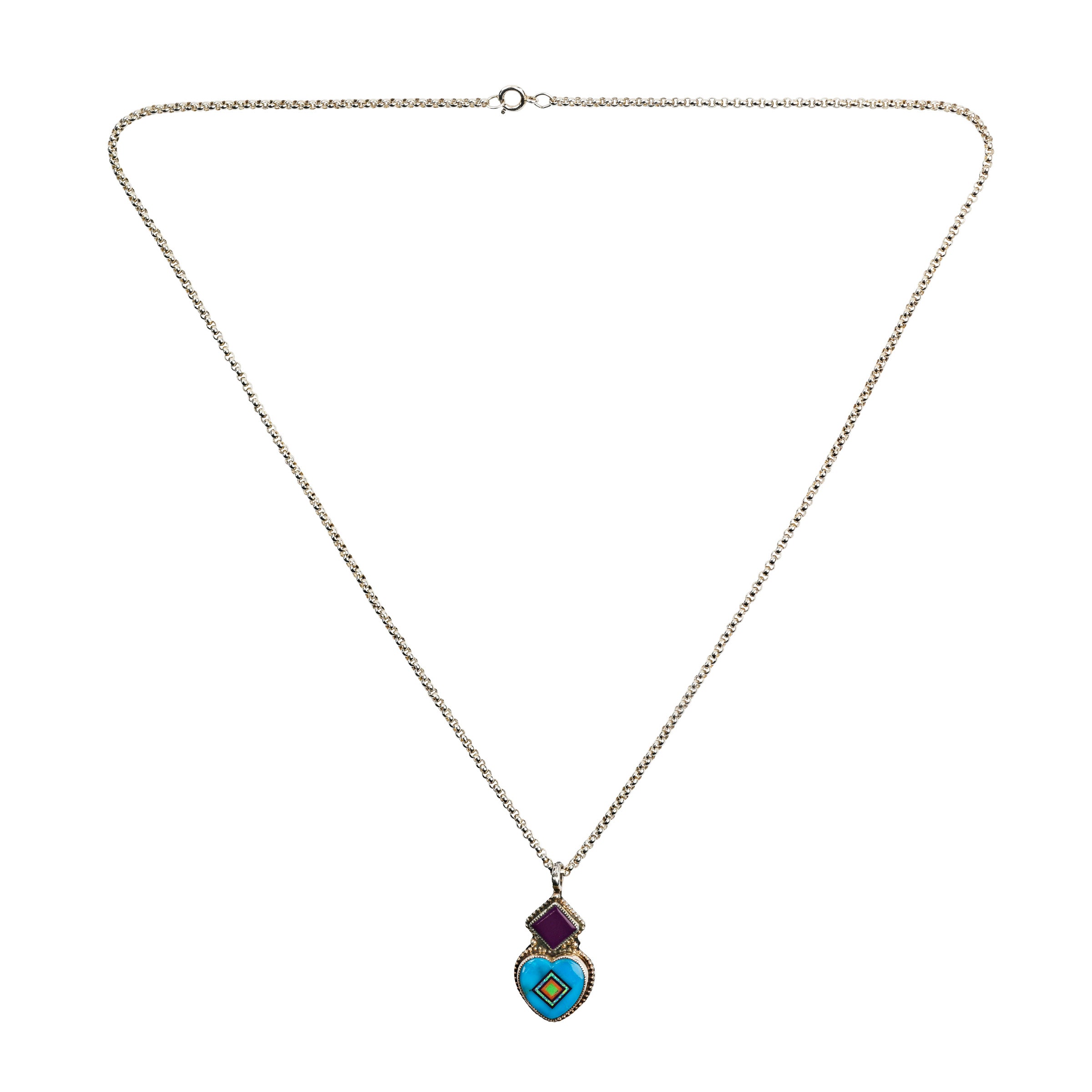 A handcrafted Sterling Silver heart necklace inlaid with Blue Turquoise, White Opal, Sugilite, Orange Spiny Oyster Shell, and Gaspeite in a diamond pattern. The heart is topped with a geometric diamond Sugilite. This pendant is strung on a 20 inch Sterling Silver cable chain
