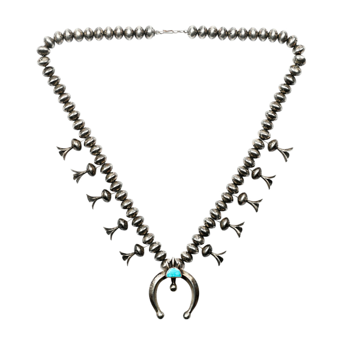 A classic vintage Navajo squash blossom necklace strung with Southwestern blossom charms and Sterling Silver naja pendant featuring blue water web turquoise stone