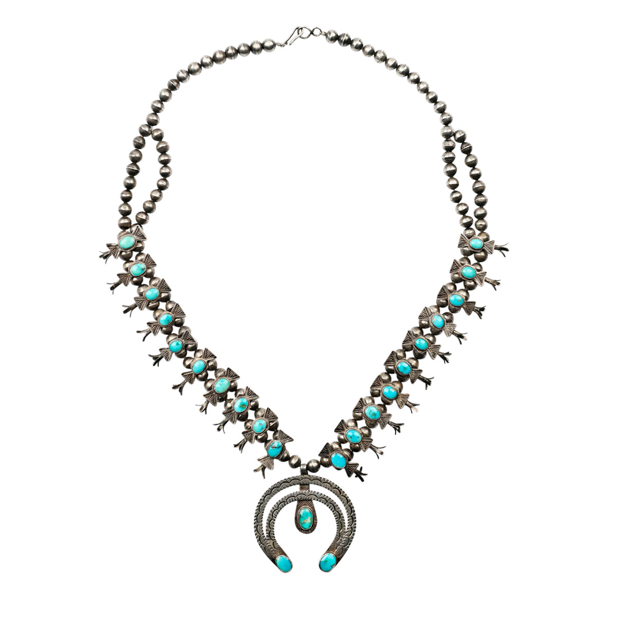 A classic Navajo naja squash blossom necklace stamped with Southwestern motif detailing and blue turquoise stones