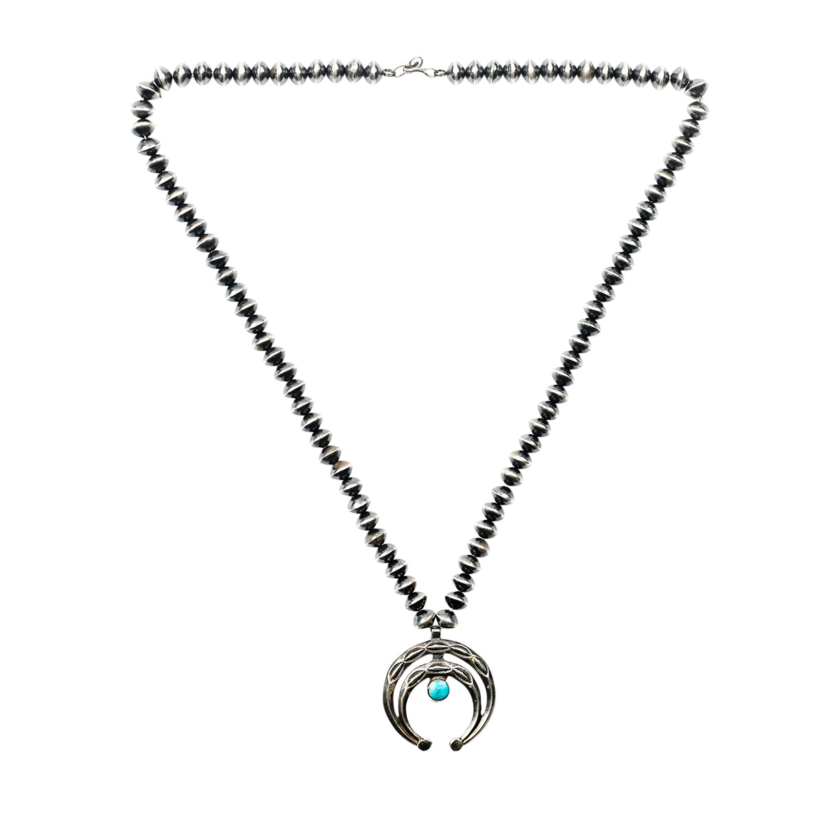 A vintage necklace featuring desert pearl saucers, a Naja pendant with geometric stamping, and blue turquoise as the centerpiece.