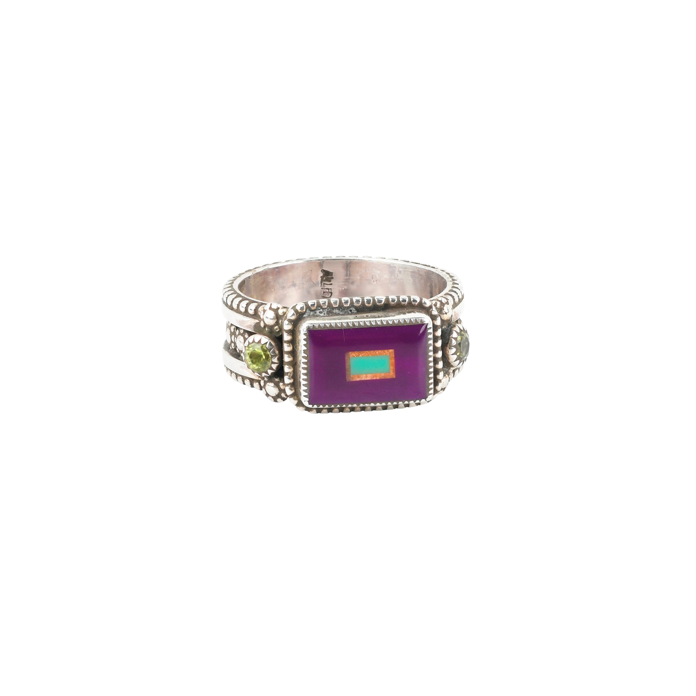 A detailed Sterling Silver ring inlaid with Sugilite, Orange Spiny Oyster Shell, Green Turquoise, and Peridot. The band of this ring features tiny blossoms and dotted detailing.