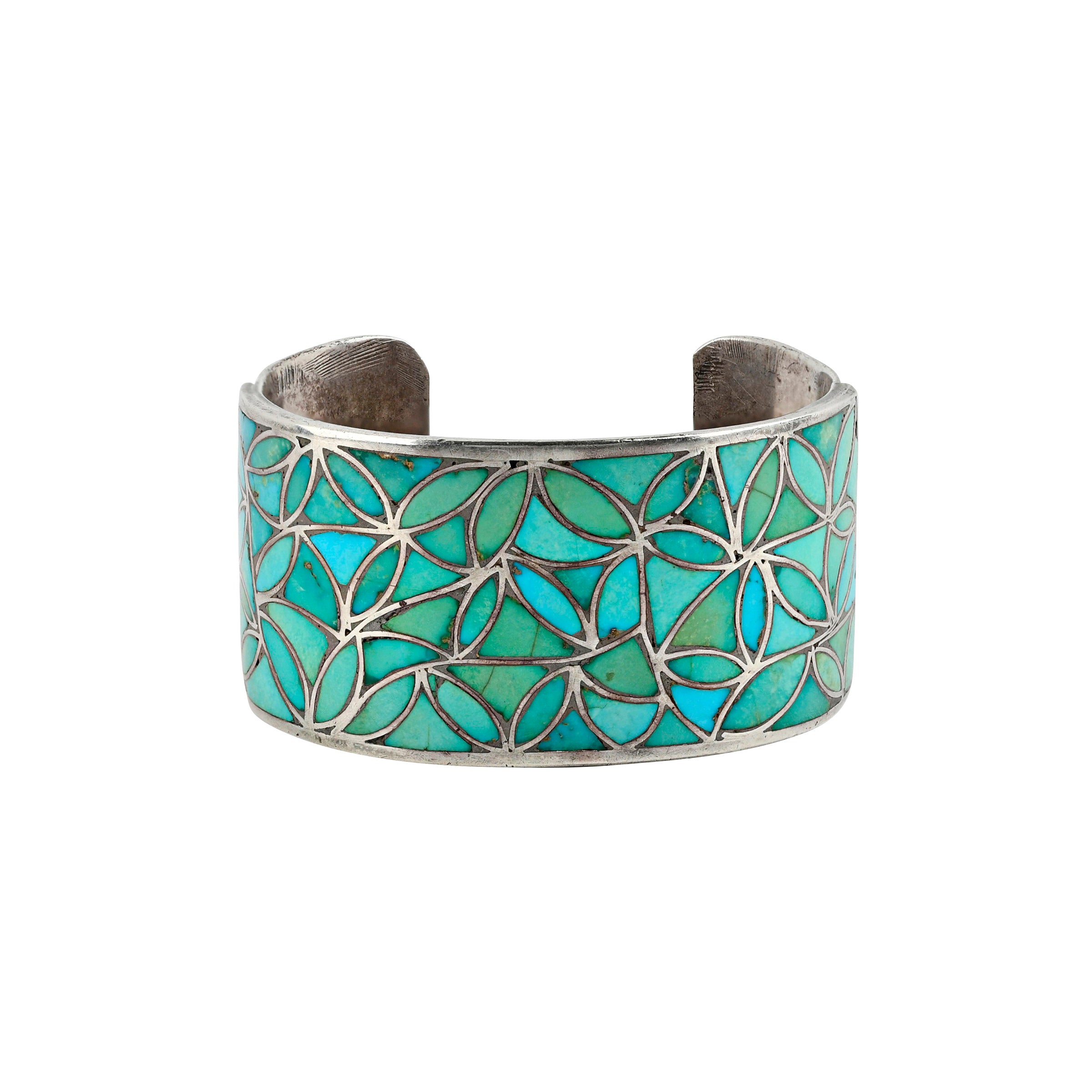 Sterling silver cuff with green and blue turquoise in geometric pattern.