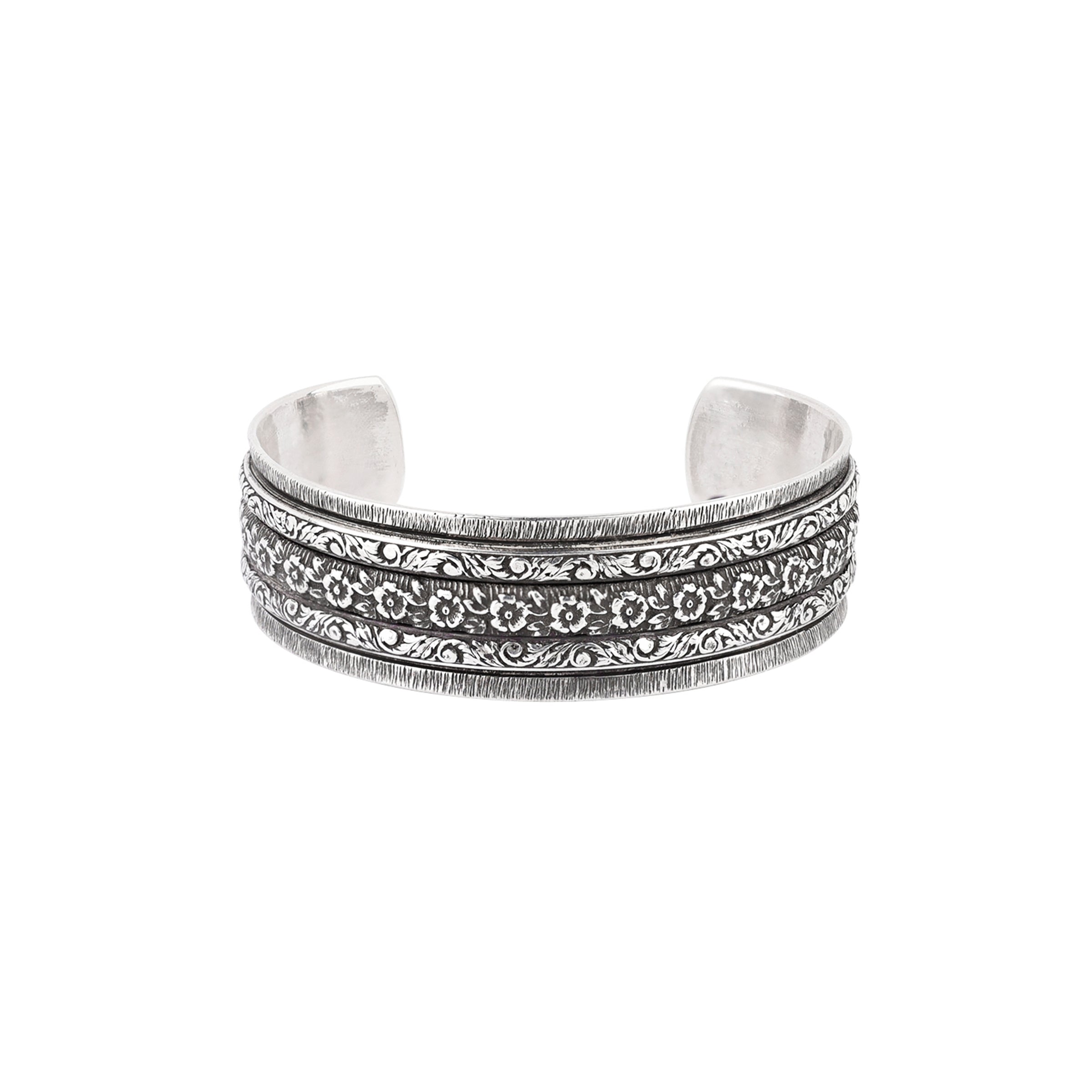 Sterling silver cuff with intricate stamping and floral design.