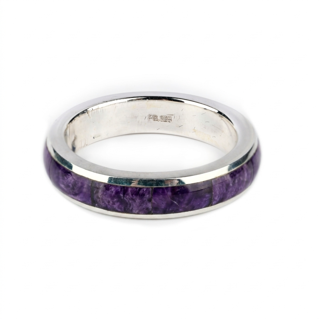 A sterling silver ring with a purple spiny oyster shell inlay.