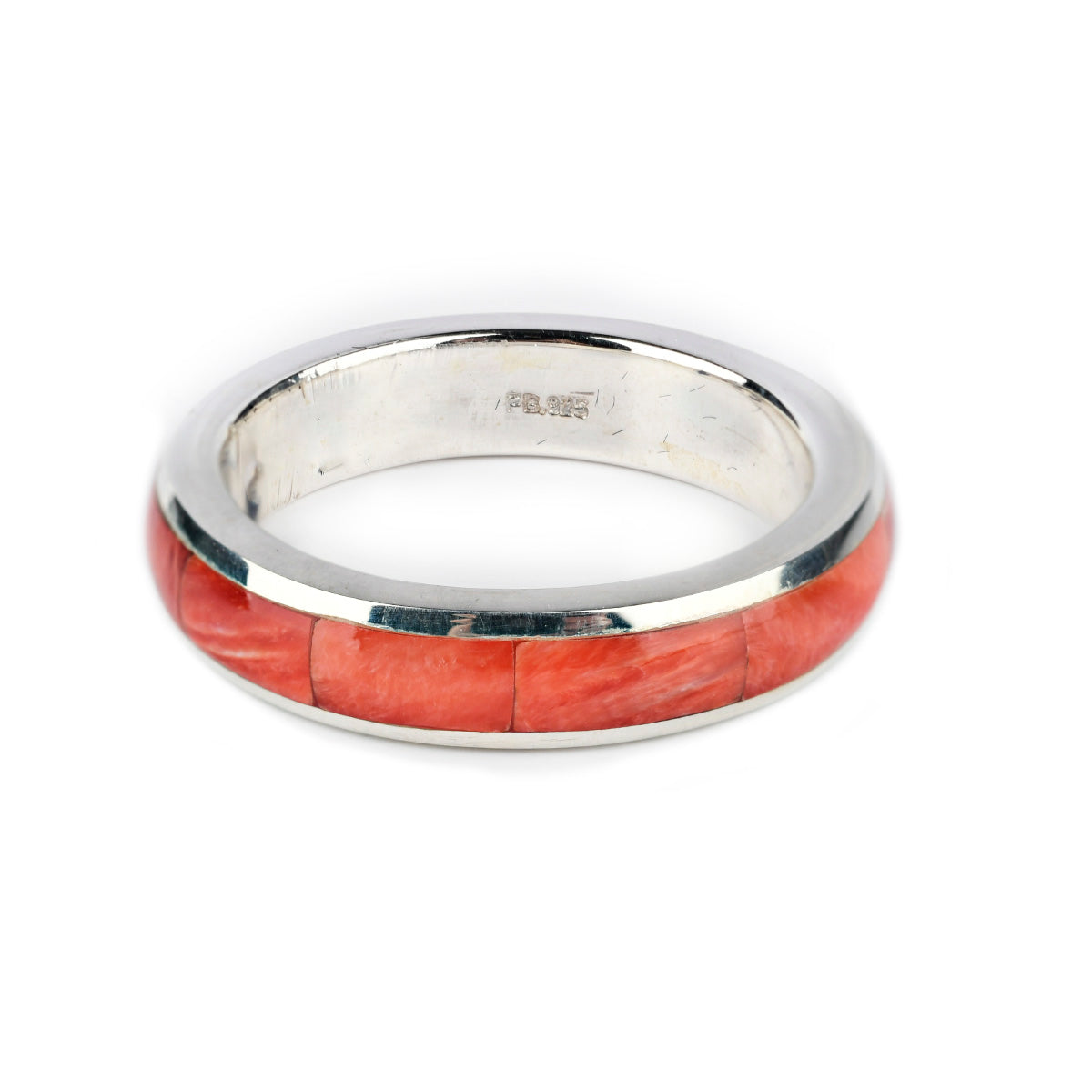 A sterling silver ring with a red spiny oyster shell inlay.