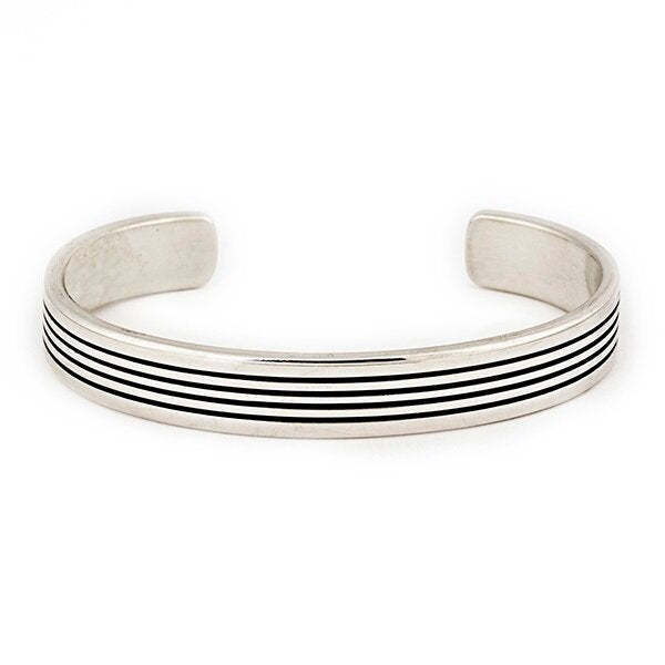 A sterling silver striped cuff from native artisan Karl Kee Nataani. Made in USA.