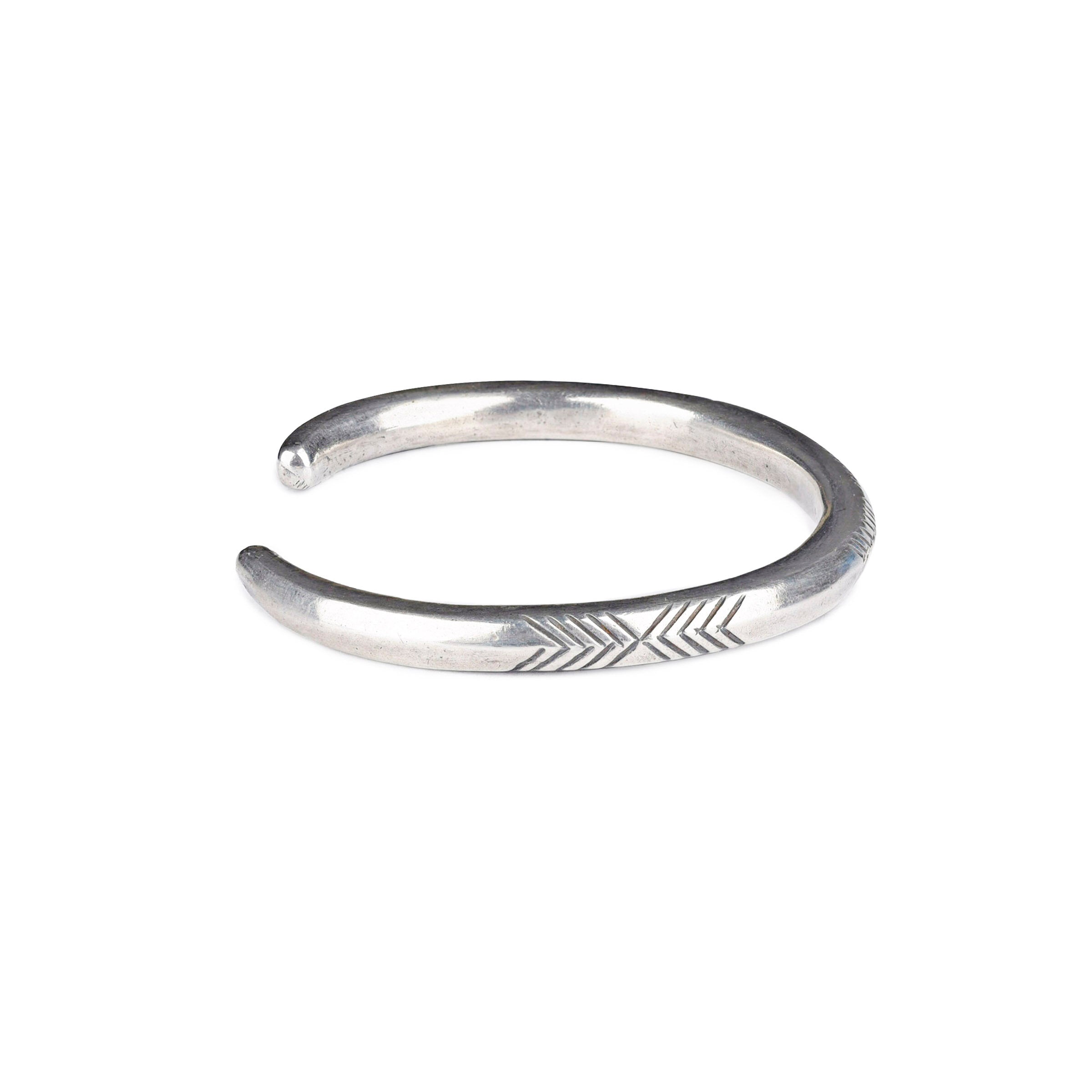 A sterling silver cuff bracelet from artisan Jock Favour with a symmetrical geometric stamped pattern. Made in USA.