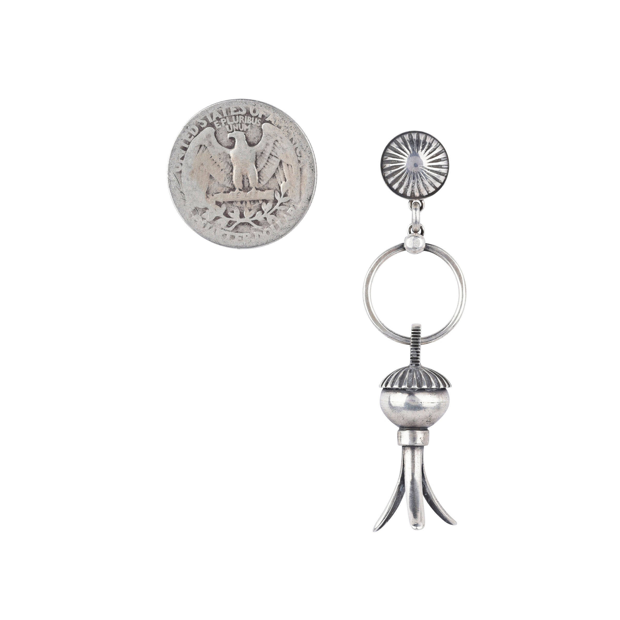 The Madrid earrings from Dennis Hogan are pure Southwest style. Featuring Sterling Silver and the iconic squash blossom with a bold concho post. These earrings will elevate any outfit.