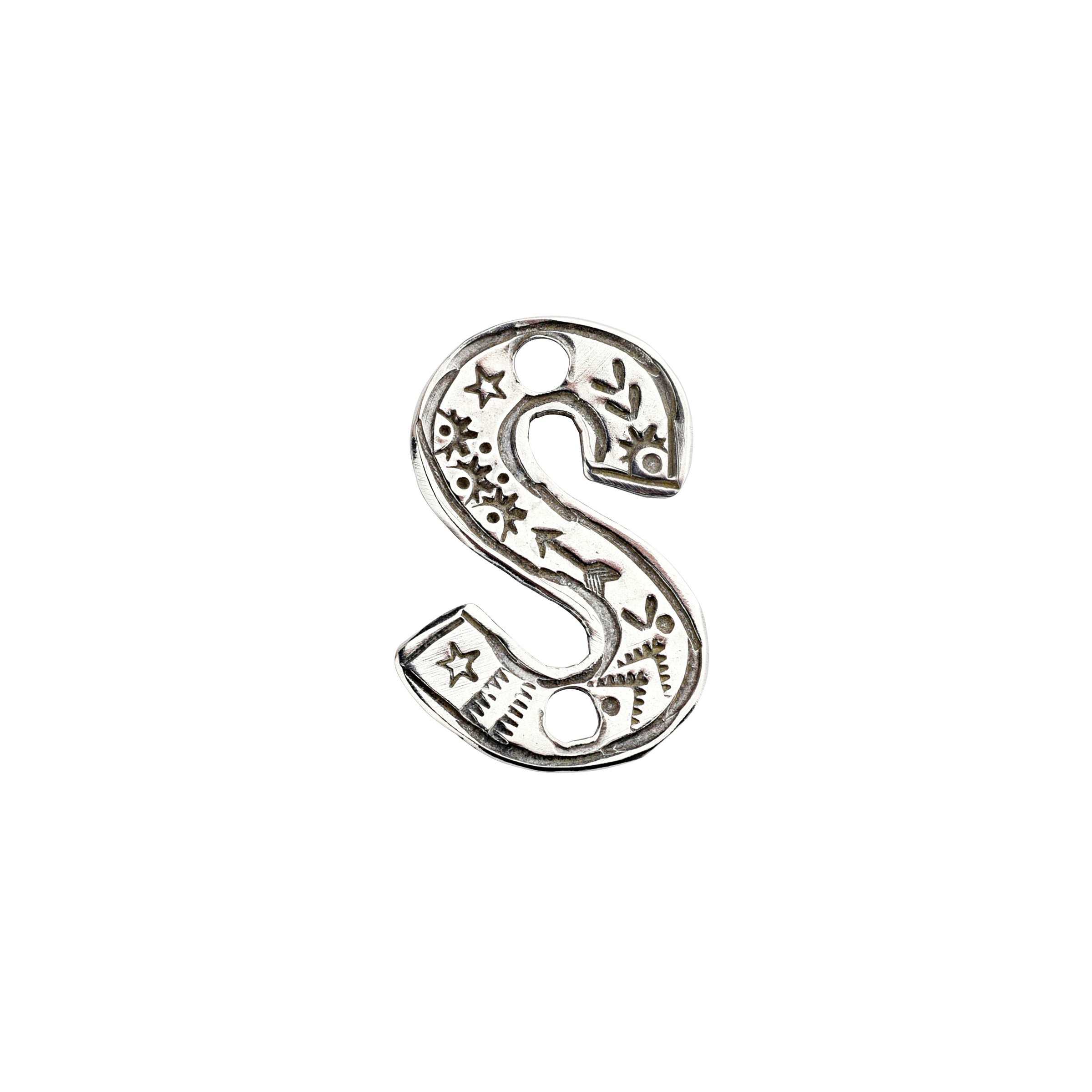 A sterling silver S Charm from artist Joe Eby that is a perfect addition to any hat or jacket.