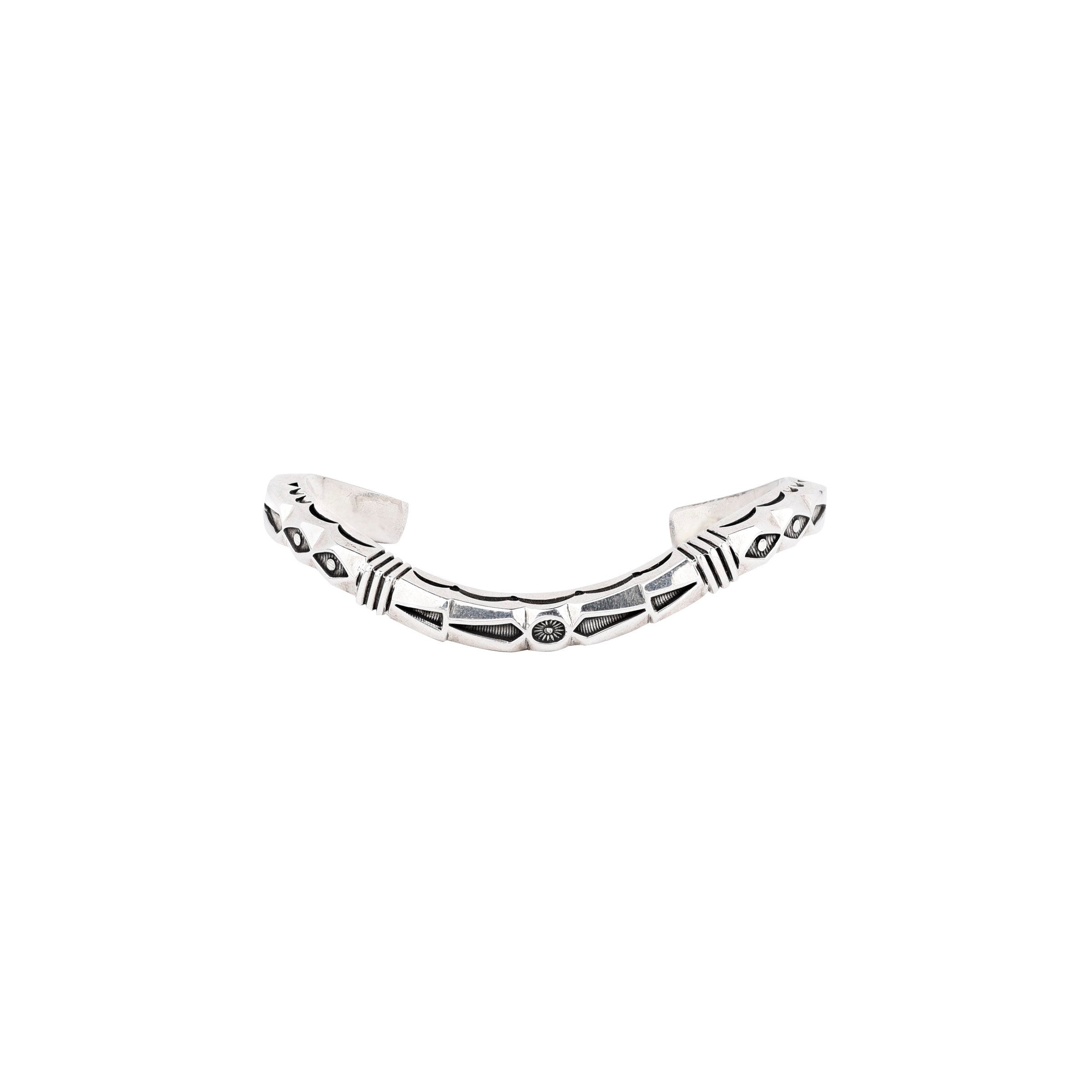 Curved sterling silver cuff bracelet from artist Jennifer Curtis. Featuring intricate stamping and design.