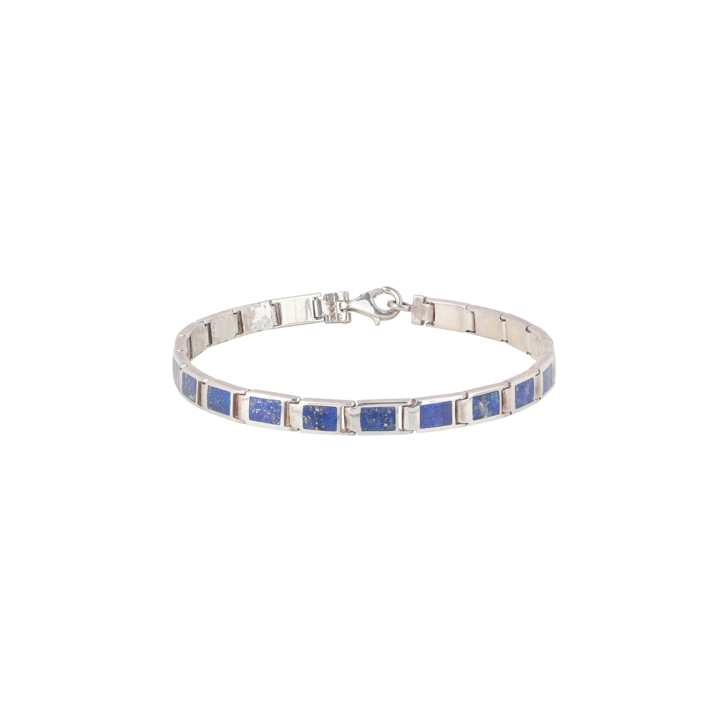 A silver bracelet with blue lapis stones, featuring a clasp.