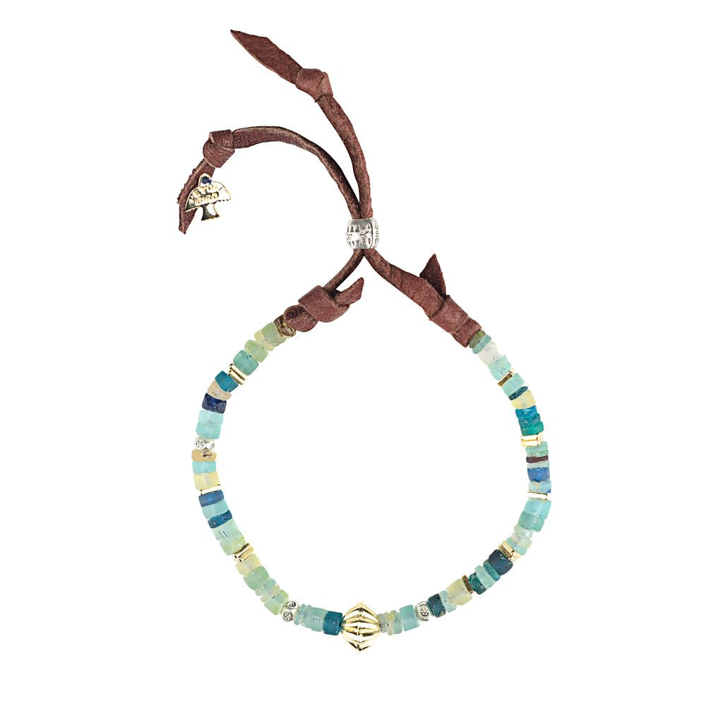An adjustable Peyote Bird Original bracelet with small multicolored beads and a larger gold bead, featuring a brown leather strap and a metal clasp.
