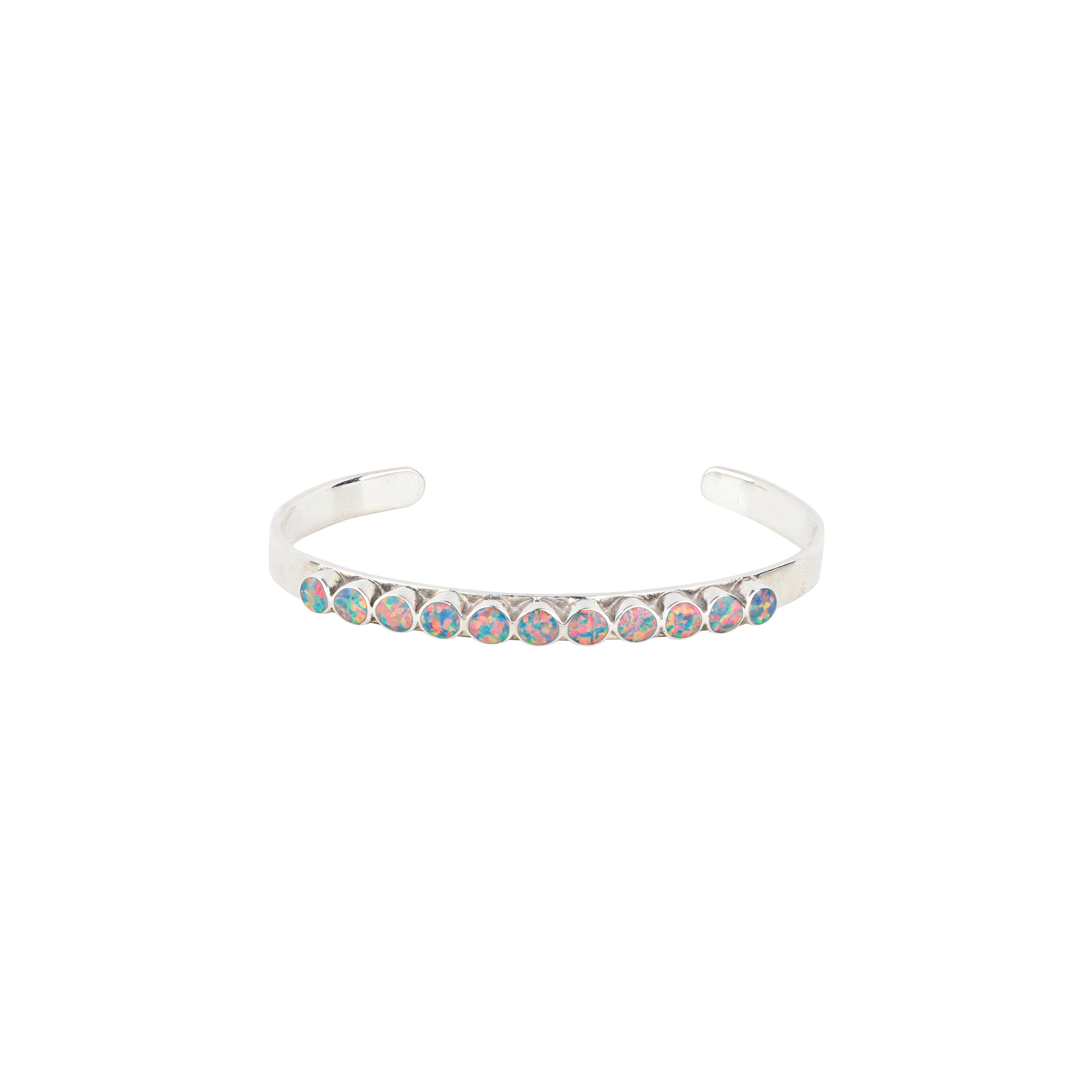 The vintage inspired Mirai cuff from our Bird and Arrow line that features sterling silver with circular dark opal stones on top of the band.  