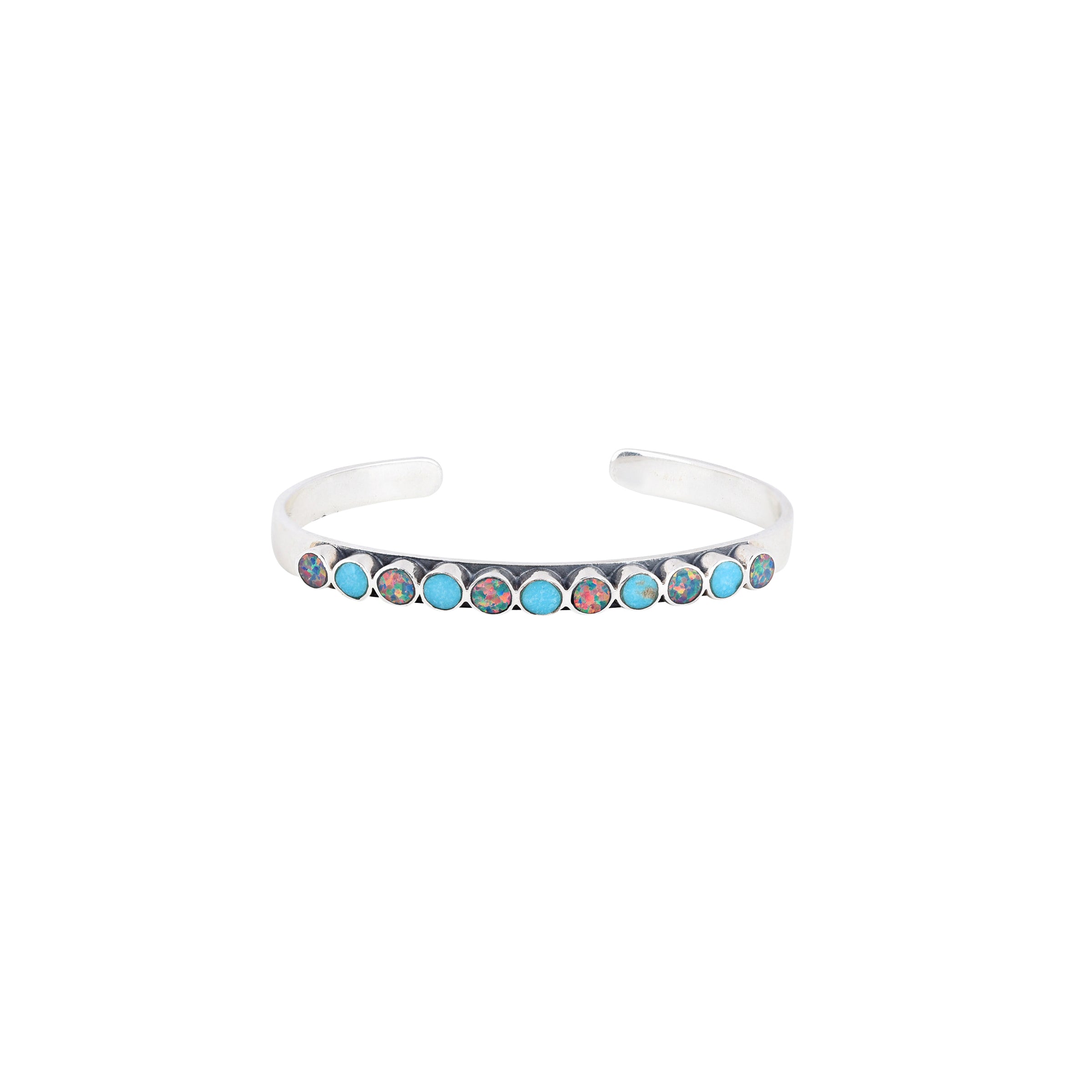 The vintage inspired Mirai cuff from our Bird and Arrow line that features sterling silver with circular blue turquoise and dark opal stones on top of the band.  