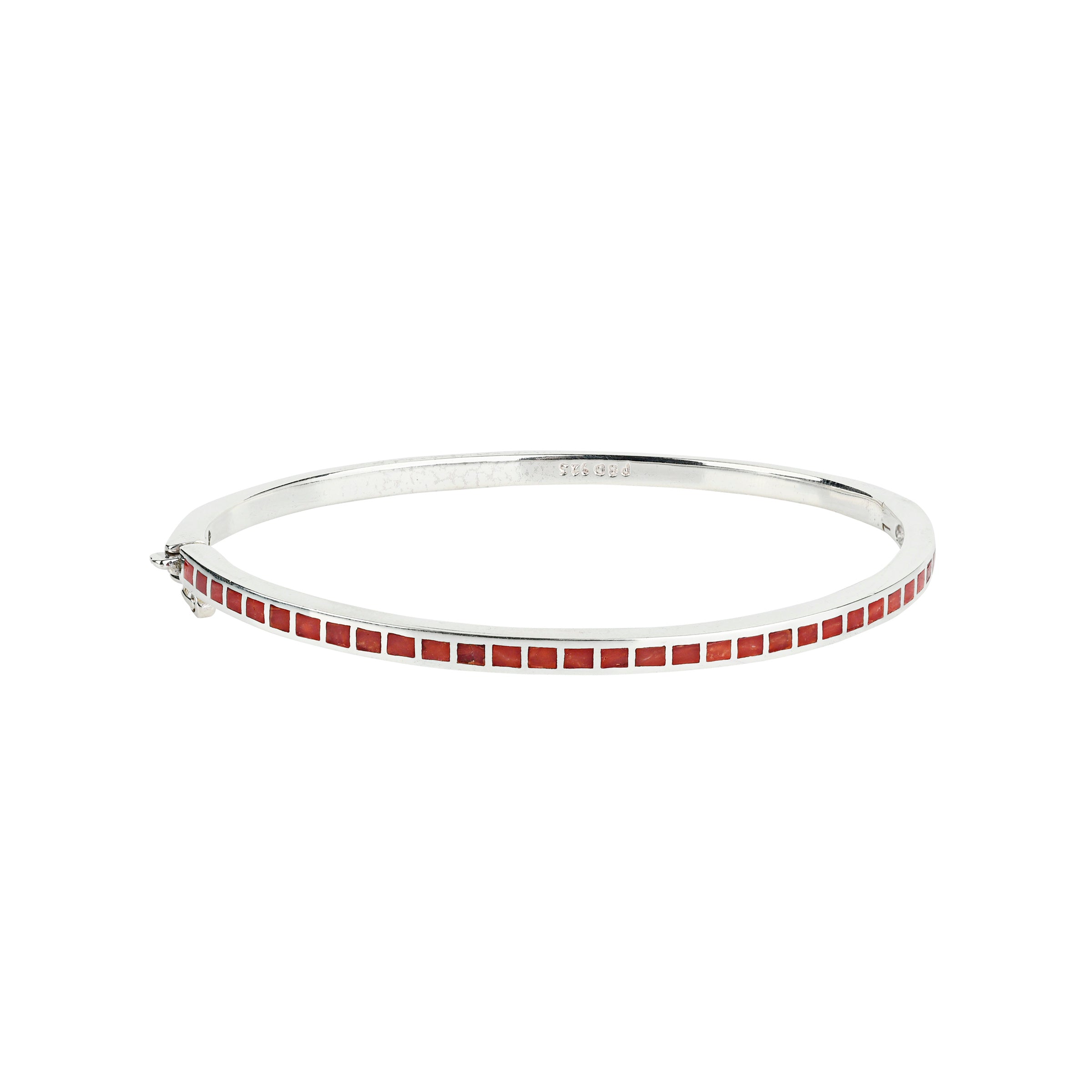 The Element Bangle is sterling silver inlayed with semi-precious stone of red coral