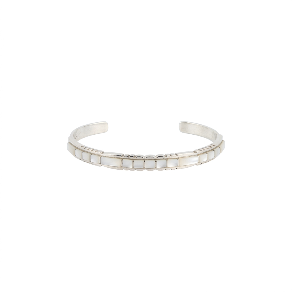 Sterling silver cuff with inlay stone detail in mother of pearl and detailing on top and bottom. front view