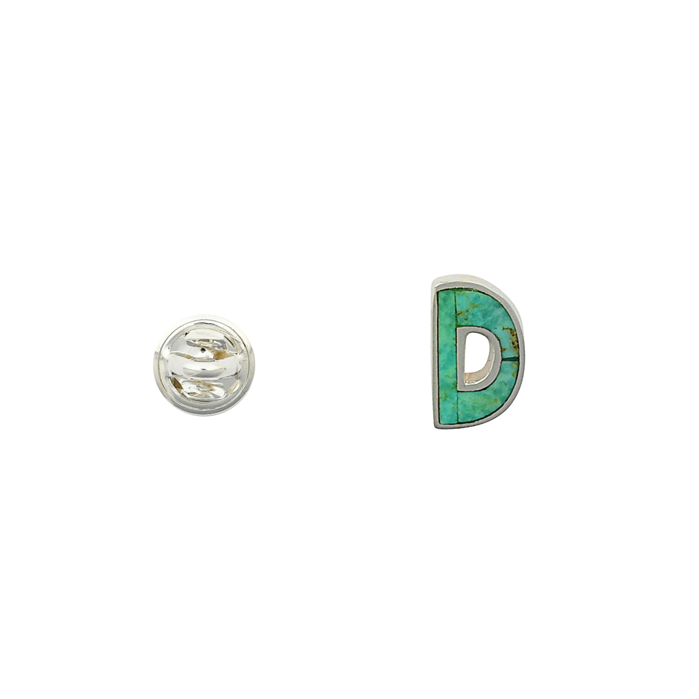 Green Turquoise letter pin D wrapped in sterling silver next to silver tack back. 