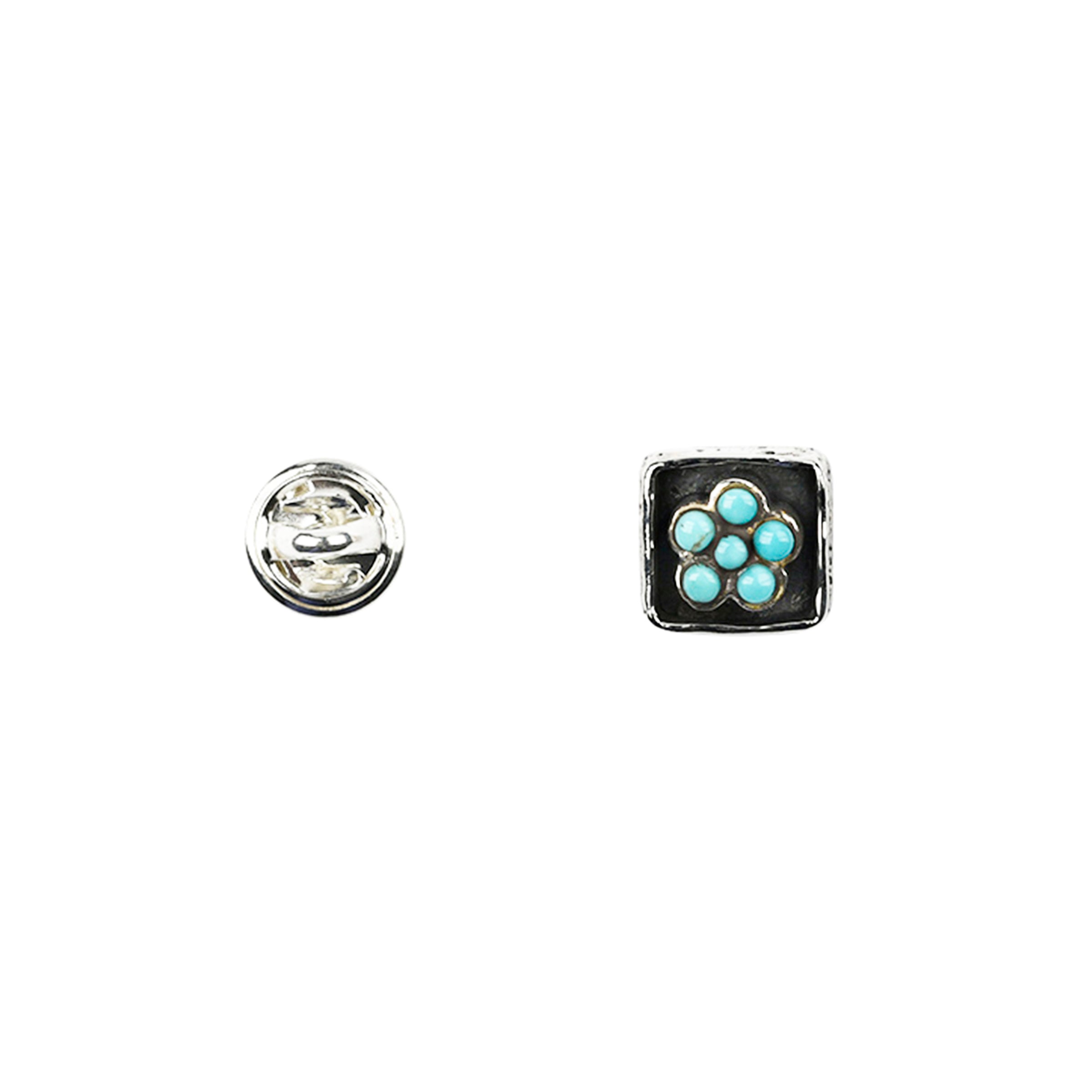 Sterling silver pin back and front with turquoise flower motif set in sterling silver square with oxidized sides around sunken flower. 