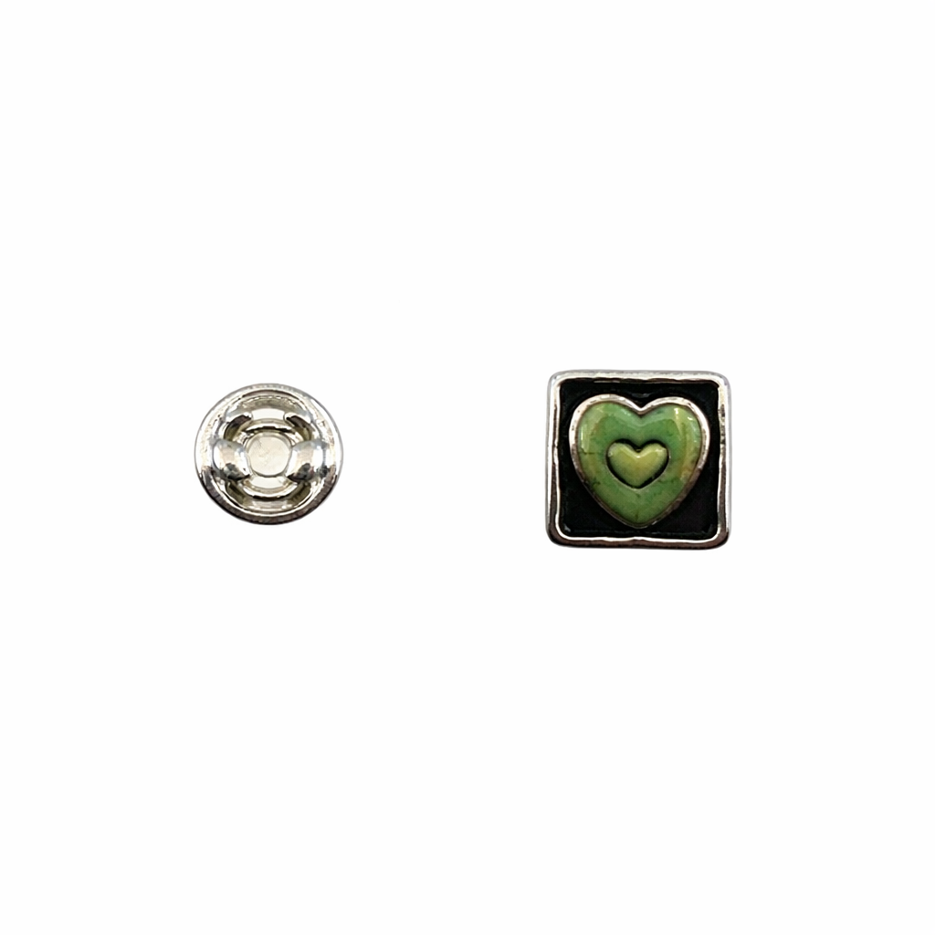 Sterling silver pin back and front with turquoise heart motif set in sterling silver square with oxidized sides around sunken heart. 