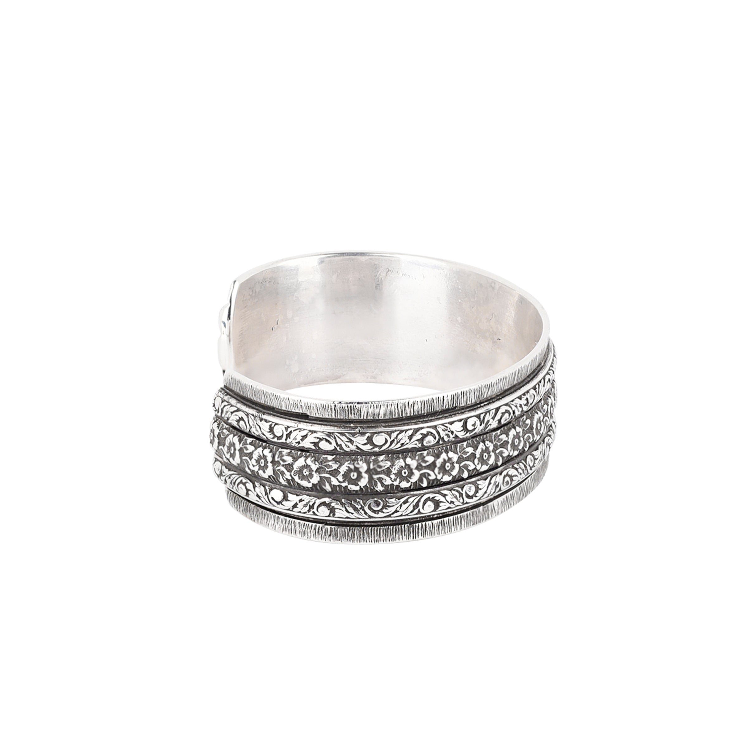 Sterling silver cuff with intricate stamping and floral design.