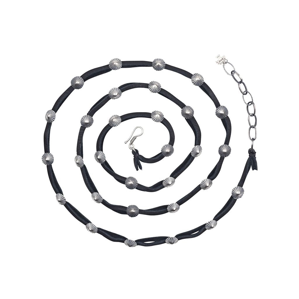 Handcrafted from soft deerskin, this double wrap hatband features classic sterling silver concho buttons. Elevate your style with this unique and versatile accessory.