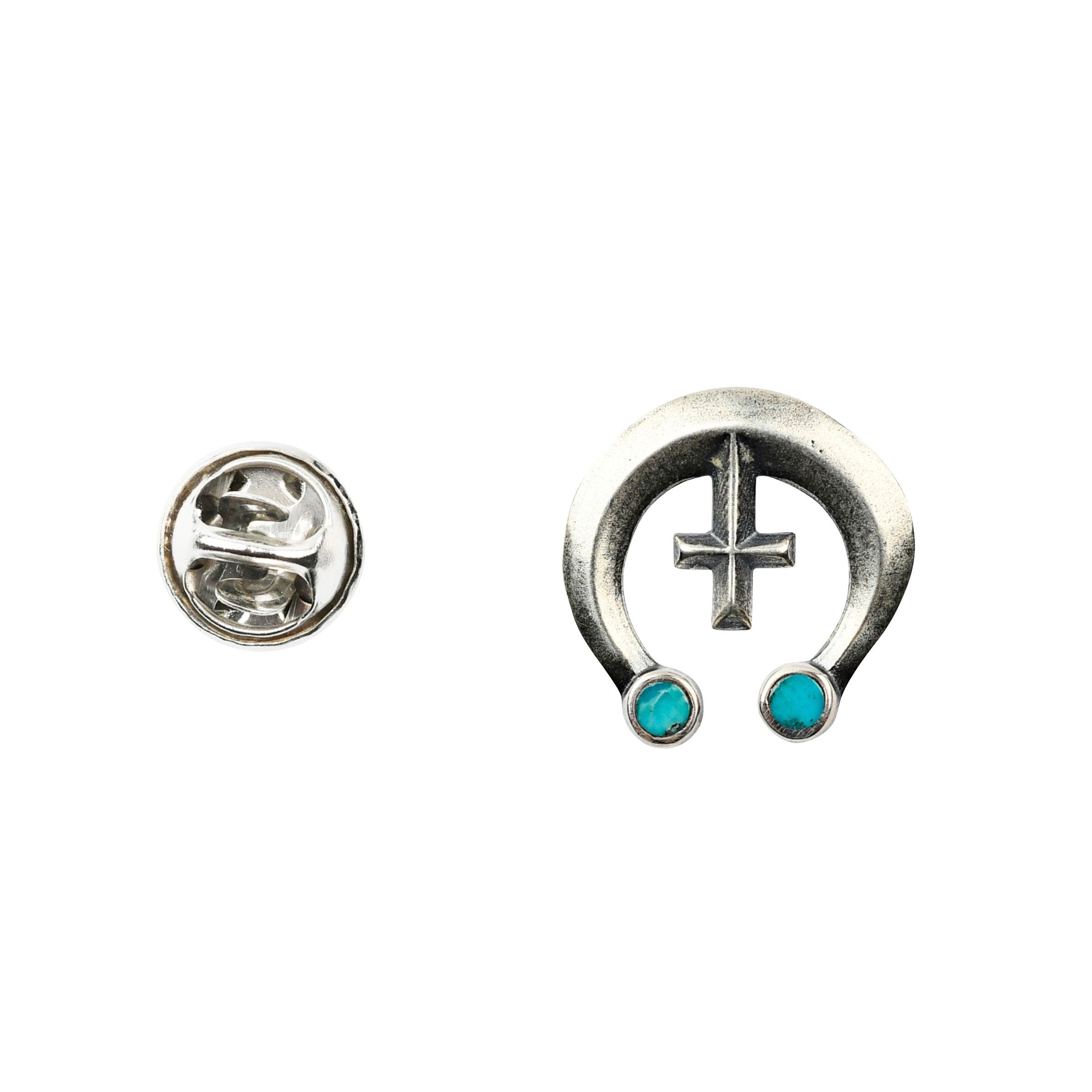 Sterling silver pin with blue turquoise stones in the shape of a naja.