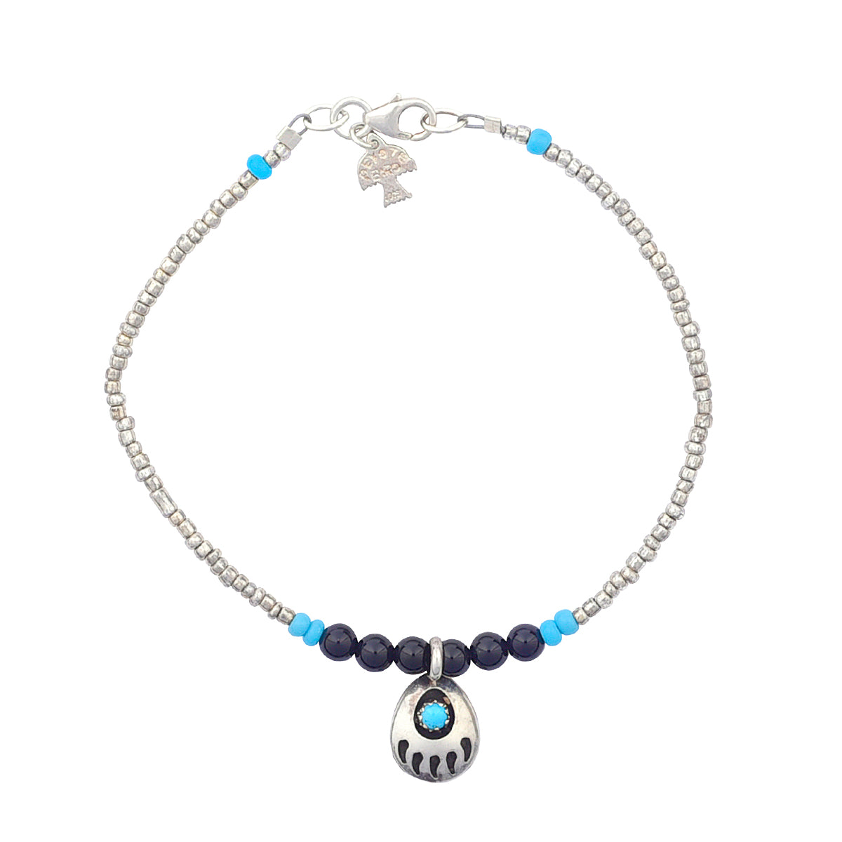 Silver glass seed beads and onyx and turquoise beads are surrounding the foal point of this turquoise inlay stone set in a sterling silver bearpaw charm on a bracelet with sterling silver lobster claw clasp. 