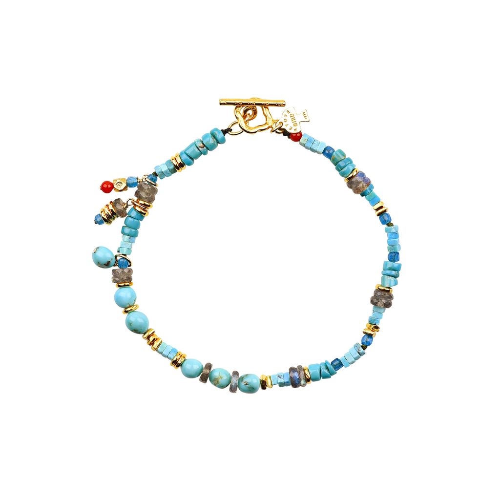 Elevate your style with our Mentor Bracelet. Crafted with gold plate and blue turquoise, accented with a pop of red coral, this beaded charm bracelet is perfect for men. Peyote Bird original. Made in the USA.