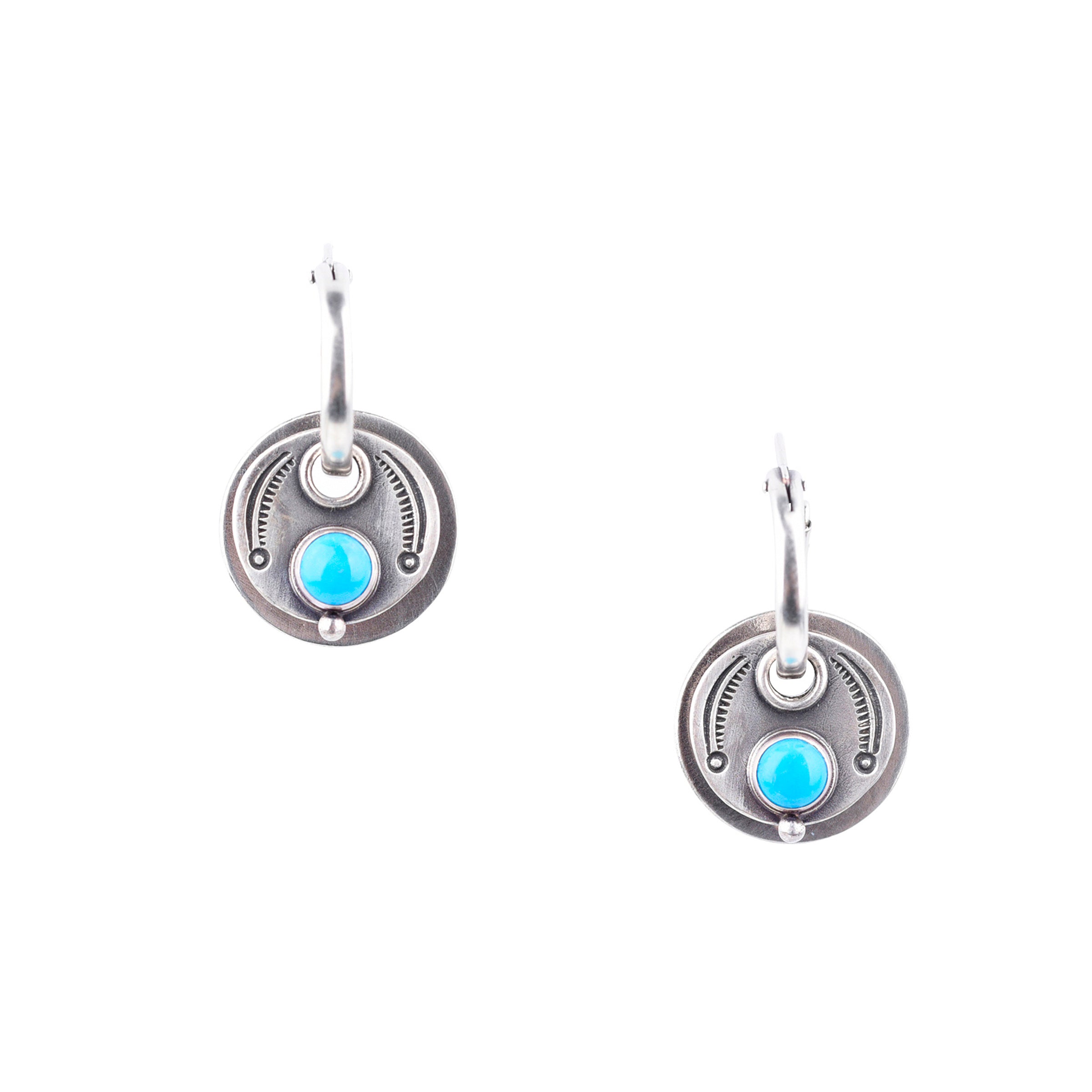 Handcrafted chic sterling silver earrings from artist Dennis Hogan. These southwest inspired earrings are highlighted by stunning blue turquoise. 