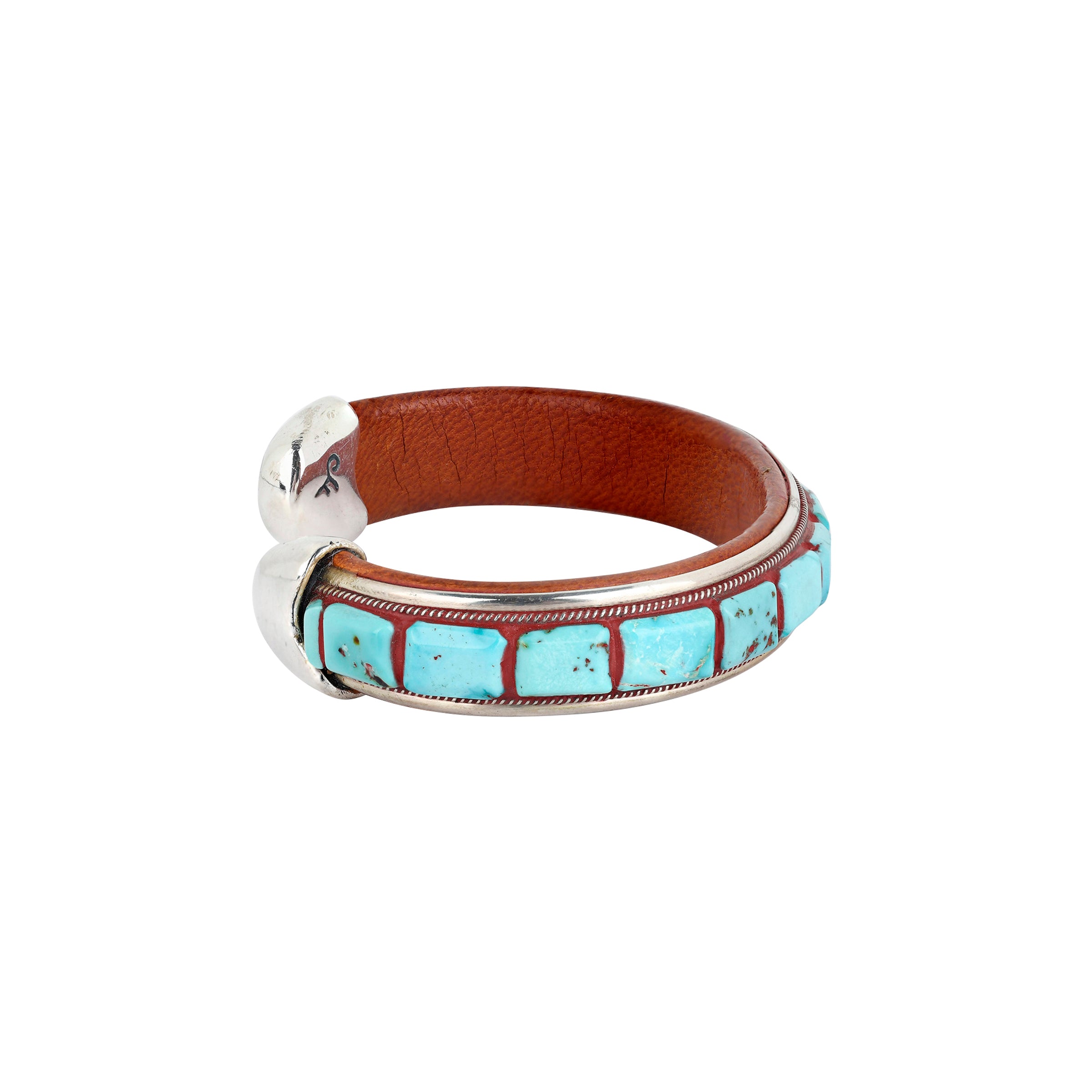 A beautifully designed cuff made of inlayed Blue Turquoise and brown leather finished with Sterling Silver tips. 