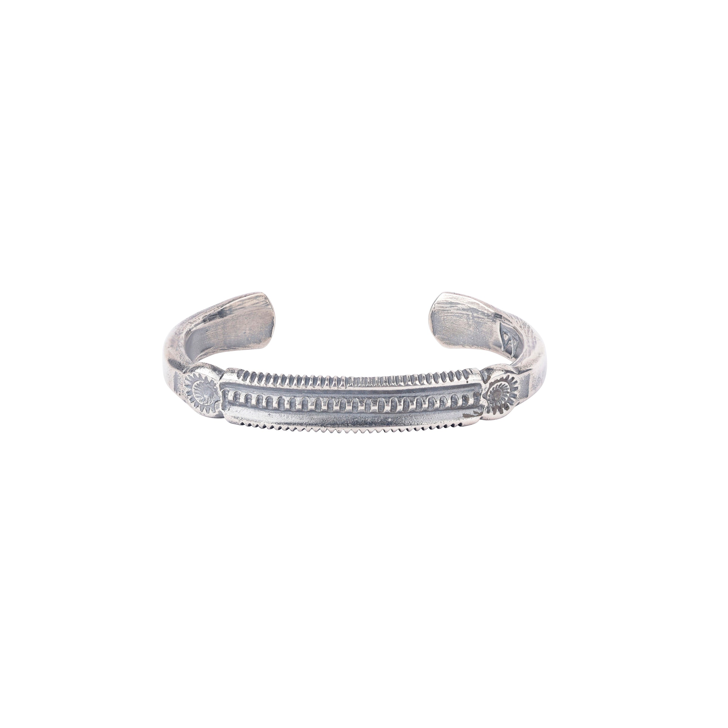 A sterling silver cuff bracelet from Buffalo with a textured and stamped design. Made in USA.